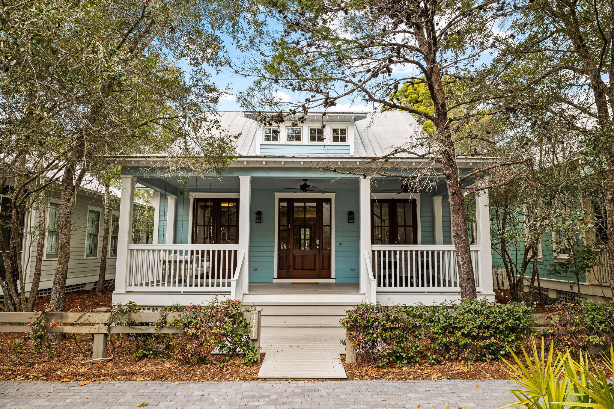 Welcome to 1261 Western Lake Drive--a quintessential Watercolor beach cottage located in the camp district and just one block from the popular Camp Watercolor.  This home features a spacious front porch for classic Watercolor outdoor living that opens into the living and dining area where you will immediately note the gorgeous soaring ceilings.  The dining area flows seamlessly into the kitchen and a hallway connects two first floor bedrooms and a screen porch & grilling area. The upstairs has two additional bedrooms, one with built in bunks--a perfect spot for kids to have their own space.  From its prime positioning, shopping & dining within the Watercolor Town Center, tennis/pickle ball courts and the recently overhauled Beach Club are all a short walk or bike ride away.