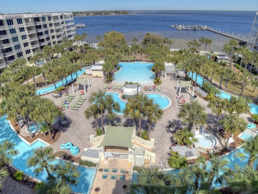 Own the best 1 bedroom penthouse on the market! This penthouse end unit offers an open floor plan with 9 foot ceilings, one master bedroom, a bunk room, and 2 full bathrooms.There's even a rooftop patio! Utilizing the sleeper sofa, this condo can accommodate 6. The covered patio off the living area fronts Lazy River lagoon pool, large heated pool, 2 hot tubs, and pleasing lush landscaping. Climb the stairs from the living area patio and enjoy the rooftop views of the bay and the Gulf, all the way to Destin! There's also a patio off the master bedroom. Calming desirable decorating and well maintained, this unit is rental ready Present owners didn't rent the unit. Destin West Gulfside and beach are accessible by a catwalk on the 3rd floor over Hwy. 98. Seller to include home warranty.
