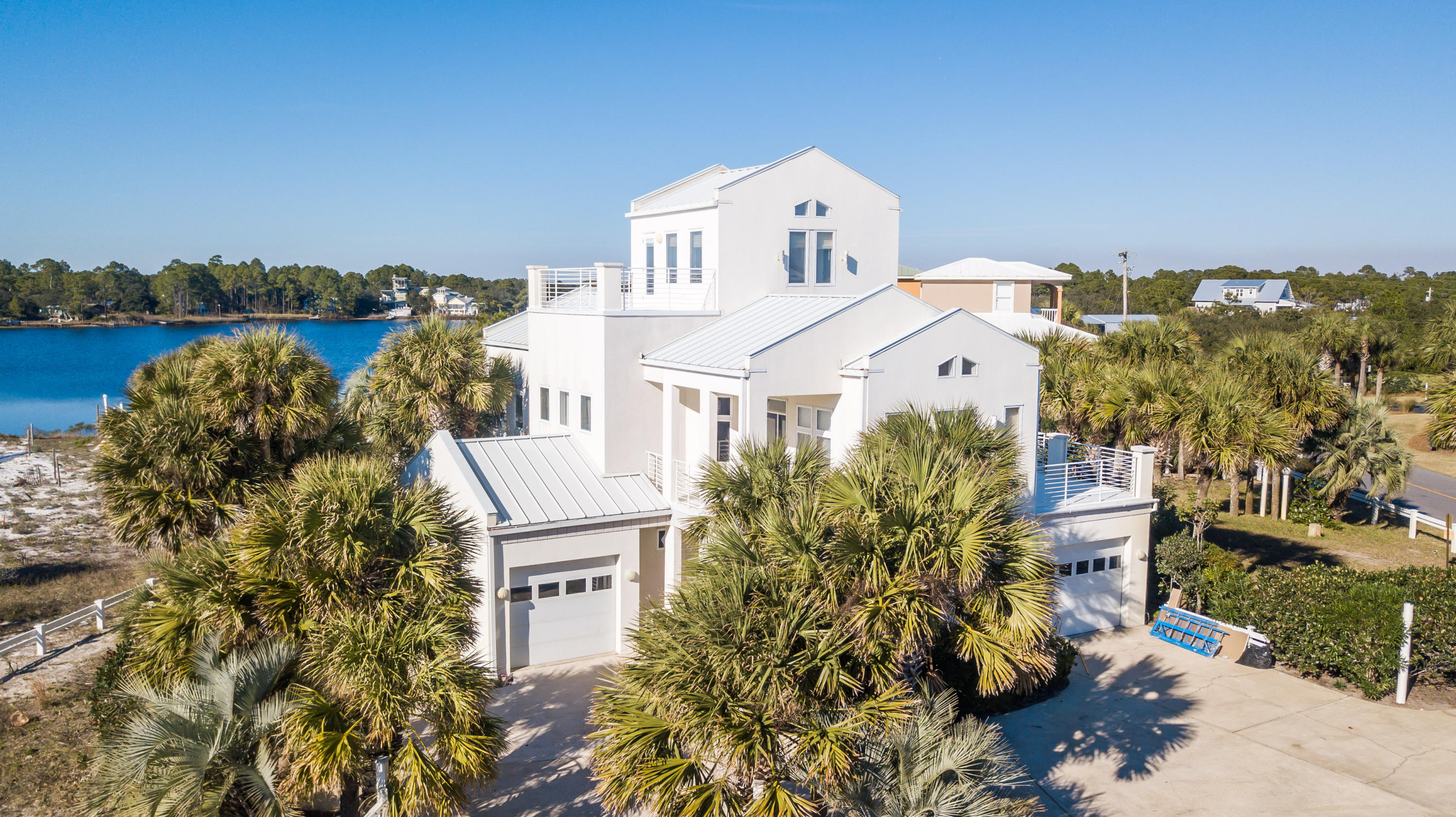 Stunning lake front property on Eastern Lake offering sweeping views of the Gulf of Mexico. Contemporary design along with astonishing architecture exemplify this incredible property. Located in Seagrove Beach, this estate offers outstanding access to enjoy all 30A offers including the sugar white sands, emerald waters, world-class fishing, first-rate dining and luxury shopping. Beach access can be found within steps of the home. This waterfront property features a private dock; private pool; separate guest quarters with kitchen; large lot; 2 private garages; vaulted ceilings, exquisite fixtures and designer finishes. The home boasts a large open concept great room featuring a gourmet chef's kitchen and large living area. The exceptional floor plan offers 4 bedrooms, 4 1/2 bathrooms 1 half bathroom. The incredible outdoor living spaces include multiple large balconies, a lakeside pergola, huge pool deck and plenty of lush landscaping. An additional outdoor storage structure can be found near the pool to store all the water toys needed to enjoy the tremendous amenities. Great rental income make this property the perfect second home, permanent residence or investment property. This unique property is truly one-of-a-kind. Do not miss this extremely rare opportunity to own one of the few lake front offerings on 30A!