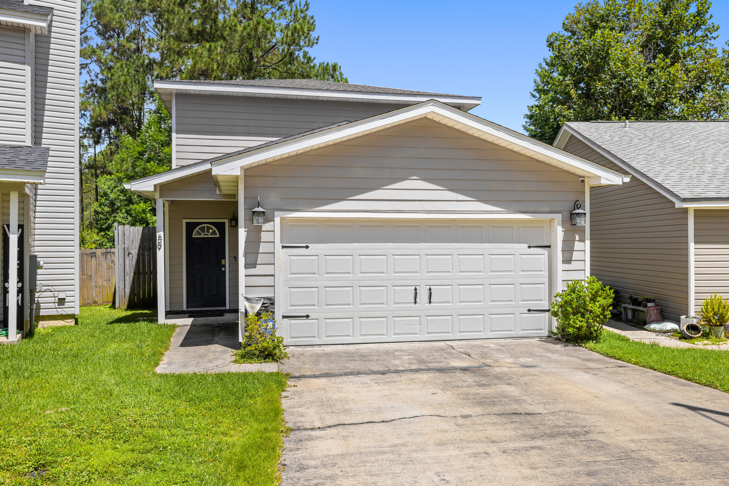 Discover this spacious 4-bedroom, 2.5-bathroom home, lovingly maintained and ready to welcome new residents. Nestled in a peaceful setting that backs onto the serene Eglin Reservation and a private lake, this home offers tranquility and natural beauty. The kitchen, equipped with all necessary appliances and a convenient breakfast bar, overlooks the main living area, creating an inviting space for family gatherings. The downstairs master suite is a retreat, featuring double vanities, a separate tub, and a shower. Stylish wood laminate floors enhance the main areas downstairs, while quality porcelain tile graces the wet areas, and plush carpet covers the bedrooms and upstairs loft. The expansive wood deck, stretching the width of the home, is perfect for entertaining and enjoying the pictur