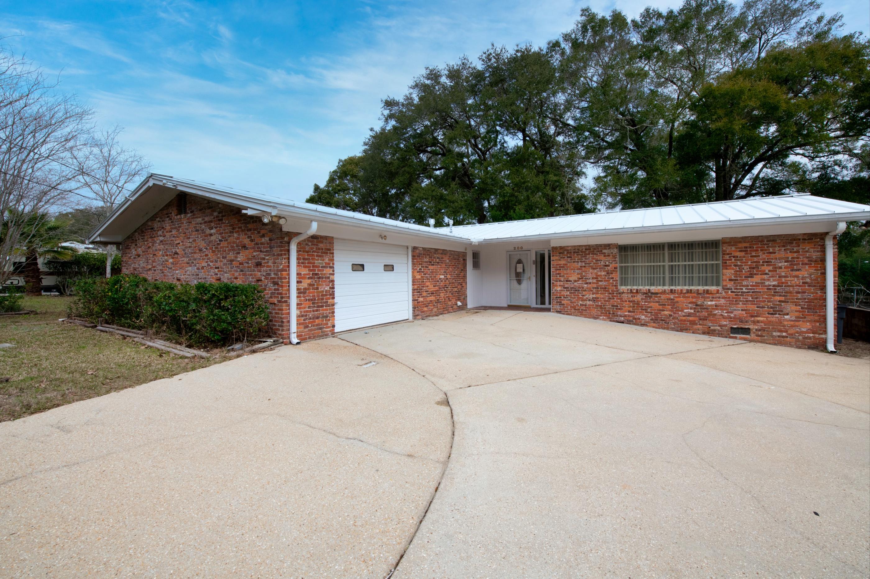 Looking for a spacious 3 Bed 2 Bath Brick Home in the heart of Valparaiso / Niceville area? Do you want to make a home your own with a few upgrades? The home is a perfect starter home or investment property with a large living area, dining room and kitchen. Flooring is tile and laminate throughout. Enjoy entertaining in the spacious fenced in back yard. Copper wiring and metal roof. One year home warranty included for peace of mind.