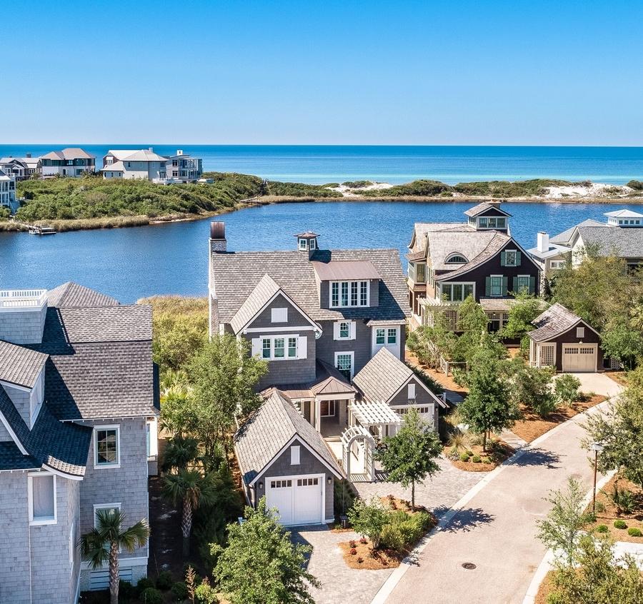 With panoramic views of a Coastal Dune Lake and the Gulf of Mexico, this exquisite lakefront home designed by TS Adams Studio is a rare find. Completed in September 2016, this like-new home has an elevator, pool, spa and four private porches. Bespoke interiors by Darci Hether NY create a sophisticated yet comfortable living experience for those who appreciate quality. Perfectly situated on one of 30A's prime lots, with five bedrooms (one finished as an office), 5.5 baths with high-end finishes throughout, privacy and views galore  this is a dream beach home. Watersound Beach is a gated community offering one-mile of beachfront for residents. Kayaking and paddle boarding and the beach are steps from this home on the exclusive gated Watersound Peninsula. Enter the first floor to a well-appointed den with ten-foot ceilings and reclaimed beams, shiplap walls and dual French doors opening to a huge private porch featuring views of greenery and Camp Creek Lake. Architecturally impressive spiral stairs lead to the second-floor dining and living room porches. Two king bedrooms with ensuite baths featuring Carrara Marble and subtle tile selections.  The master suite features soothing silk wallpaper, a custom porcelain surround fireplace, stunning Niermann Weeks Calais chandelier. The screened porch, perfect for morning coffee has lake views and also overlooks the peaceful, Zen-like pool. The master bath has heated floors and marble throughout. The first floor is completed by a laundry room that exits to the boardwalk or one of two garages.

The great room and dine-in kitchen take advantage of sweeping views of Camp Creek Lake and the Gulf of Mexico with a wall of windows and huge outdoor porches with a double-sided fireplace.  Vaulted Ceilings soar over the grand great room which features reclaimed beams and a show stopping, artfully designed Dominican shell stone fireplace. The effect is sophisticated yet welcoming coastal elegance.

The large gourmet kitchen is a chef's delight and will make entertaining friends and family engaging. With Wolf and Sub-Zero appliances: double oven, warming oven, 48" cooktop with griddle, 30" wine refrigerator and 42" French door refrigerator/freezer. Dual dishwashers make clean up easy. The countertops are an exquisite marble and the expansive island features a Wolf microwave drawer and ice maker. Thoughtfully designed cabinets and a walk-in pantry make cooking and storage a breeze. Standing at the porcelain farm sink, you have a view of the quiet pocket park and trees across the street.  Thoughtfully designed under cabinet lighting enhances the Ann Sacks sea-colored arabesque tile.  The outdoor kitchen features a Fisher Paykel DCS 48" professional grill.

A large master bedroom on the second floor has been fitted with cabinetry to use as an office. The adjacent full bath is tiled with marble with exceptionally designed zero entry shower and beautiful flooring.

The third-floor suite has extensive water views from the reading benches that line the windows in the den and the bedroom and features one full bed and one bunk with a cupola for extra light and visual interest. Separate bathroom and ample attic space.

This masterpiece home built by Gulfview Construction includes more than seven years on its ten-year transferable builder warranty.  EF San Juan warranted Weather Shield windows and doors, Nikzad French Oak engineered flooring, Ann Sacks tile throughout the kitchen and baths. Lighting throughout curated by Darci Hether via Circa in NYC and is primarily Visual Comfort brand. Vilroy and Bosh and Kohler sinks, Rohl Italian polished nickel fixtures throughout the house and custom window treatments and sun shades complete the luxurious interior design. State of the art Control 4 home network for security, audio and visual systems integrated into the home build by Innovative Sight & Sound, along with a Ubiquity mesh network throughout the home and porches for robust WiFi connectivity. Two Navien tankless water heaters are located in the garage, supplying endless hot water on-demand.  The home also includes a transfer switch for a natural gas back-up generator.

Exterior features true to Watersound's Nantucket design include cedar shingles, wood shutters, copper roofing accents, gutters and rain chains, Dominican shell stone walkways, slurry-painted brick, an architecturally unique courtyard fountain, arbors and copper fountains at the spa and pool and a small fenced lawn. A lightning rod system was built into the home for added security and protection. The property has two garages, one includes an add-on storage shed, a golf cart space, outdoor shower and under home paddle board storage racks.
Please see aerial video in photos section.