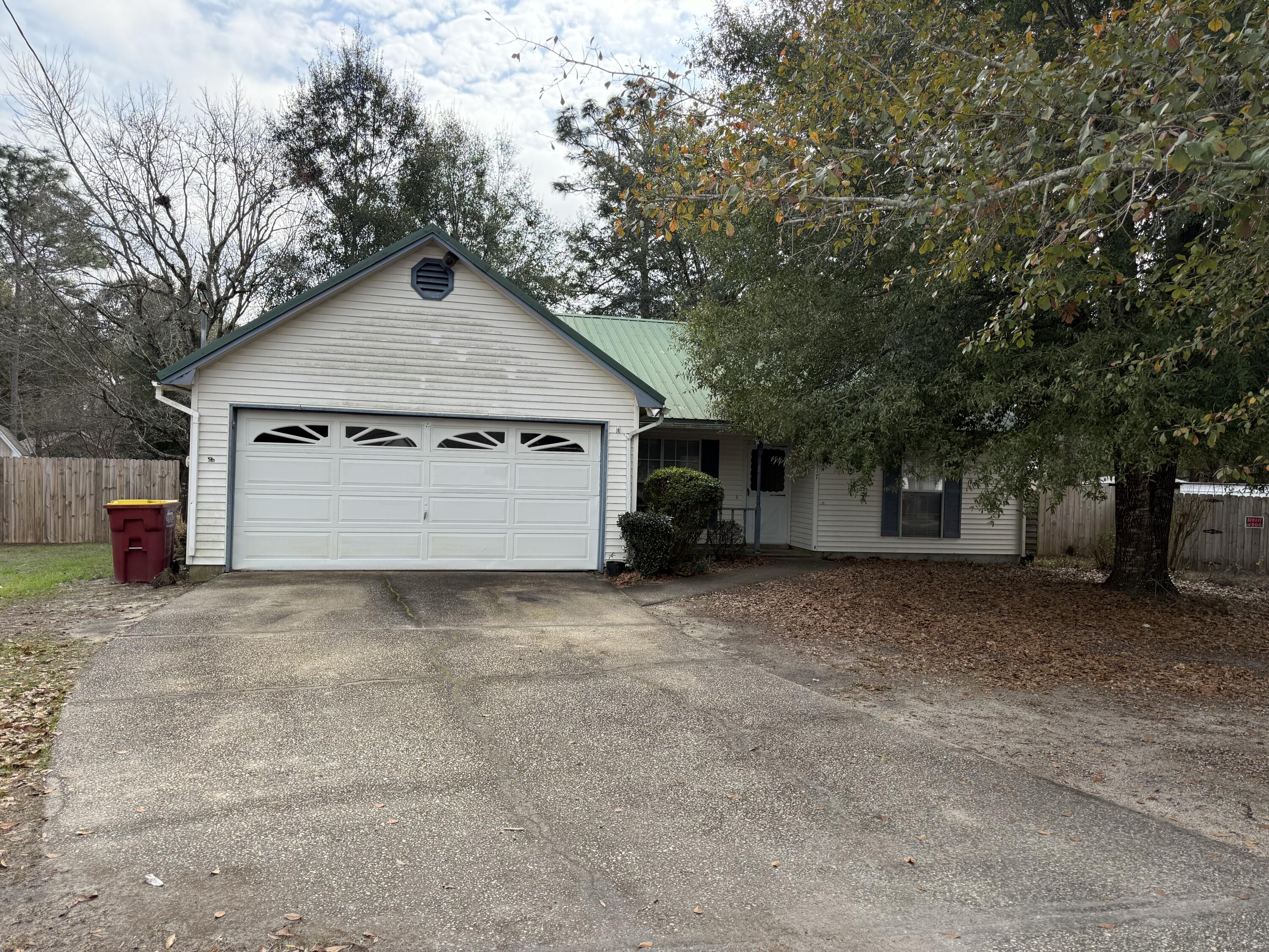 Located south of I-10, this professionally maintained 3-bedroom, 2-bathroom home includes a 2-car garage and an entirely fenced backyard. The living room showcases durable wood laminate flooring, a beautiful stone fireplace, and vaulted ceilings complemented by a ceiling fan. A formal dining room, also featuring wood laminate flooring, leads to a spacious kitchen equipped with tile floors, an eat-in area, a breakfast bar, dishwasher, stove/oven, refrigerator, and pantry. The split floor plan offers privacy for the bedrooms, each furnished with wood laminate flooring and ceiling fans. Additionally, a screened-in porch provides a scenic view of the backyard, rounding out this inviting property.