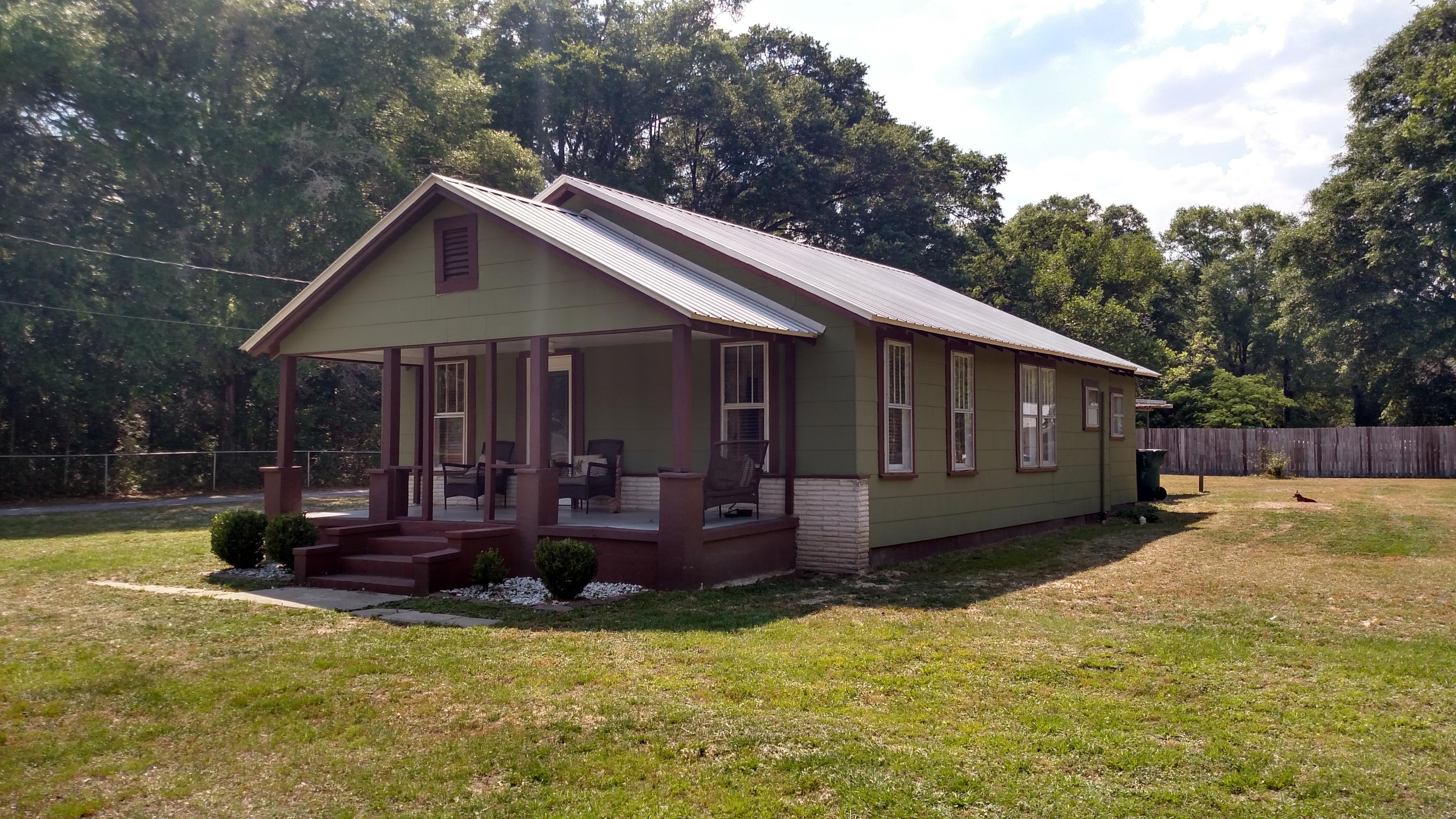 Nestled in the sleepy little town of Defuniak Springs.Charming Florida cottage awaits you. The large cover porch is perfect for those long summer day over looking .45 of a acre fenced yard. The dinning room greets you as you enter the front door with new wood plank flooring that runs through the living room. The kitchen is just steps away and fully equipped solid wood kitchen cabinets and newer appliances. All three bed room are to the rear of the home. A hall bath is shared and the 2nd bath is just off the third bedroom. A large laundry room is centrally located with access to the rear car port. A large storage shed offer additional storage. Fresh paint on the exterior with metal roof. Don't miss out on this gem.