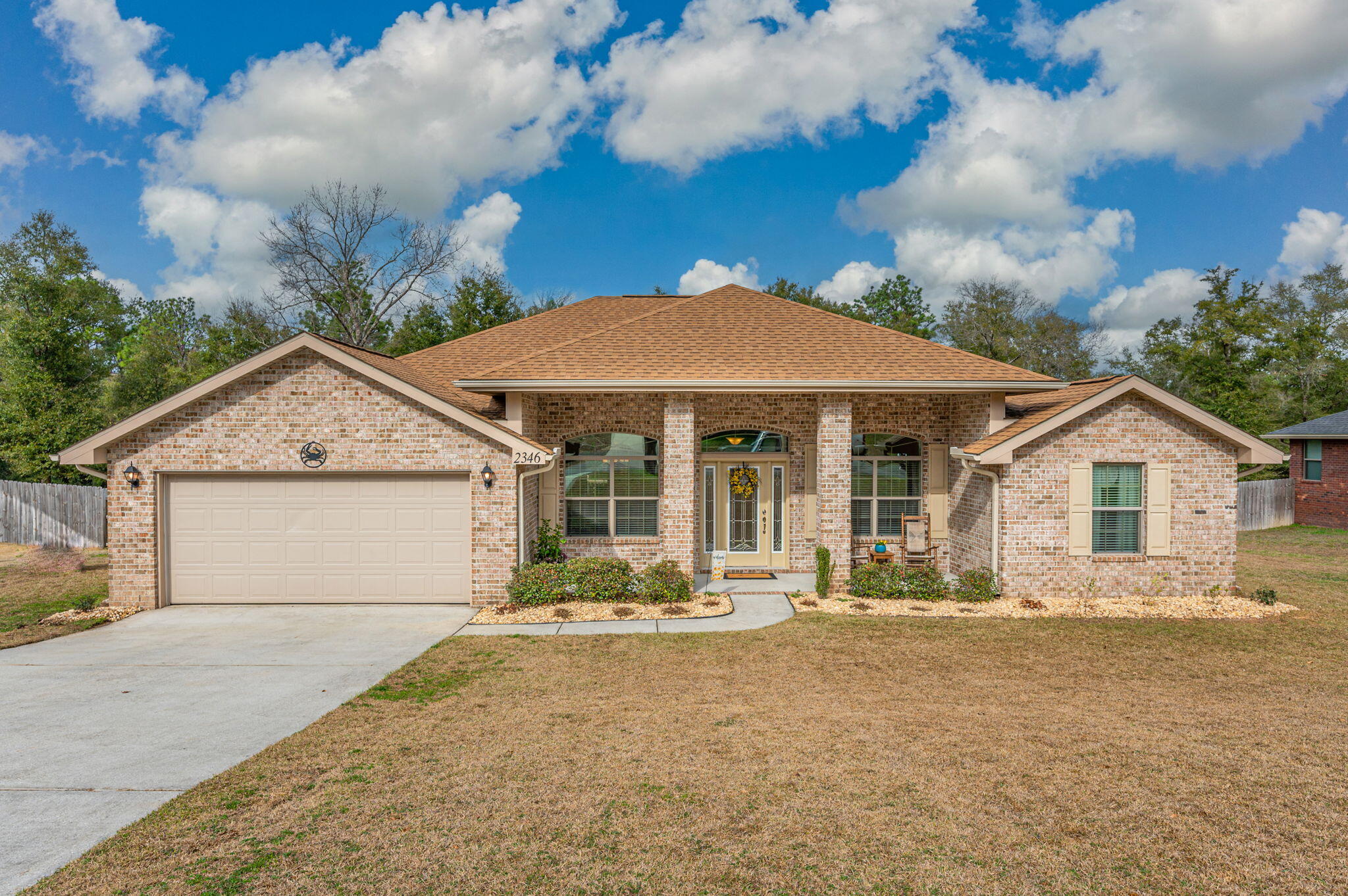 This 4/2 home is situated on over 1/2 acre lot. When you enter the home, you are greeted into a large foyer with office/playroom to your right and a formal dining area to the left. Continuing in, you will enter a large livingroom, w/ wood burning fireplace. The kitchen features a breakfast bar, stainless steel appliances, ample cabinet space, pantry, & granite countertops. Just off of the kitchen is the laundry room with plenty of extra space!  The generously sized primary suite offers a tray ceiling, two walk-in closets, soaker tub, double vanity, and an entrance to the covered back porch. The additional three bedrooms are all spacious as well. Head out back and relax on your covered porch and enjoy your view of the fenced in backyard.