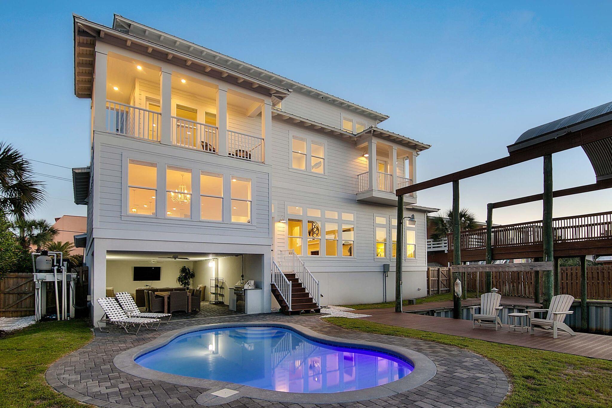 Amazing canal views and convenient deeded beach access on Destin's Holiday Isle make this incredible home the ultimate retreat for boaters who love the beach. This newly constructed three-story property sits just across the street from the sand on famed Gulf Shore Drive and backs up to a canal that leads to the Destin Harbor and ultimately to the Gulf. Two covered deep water boat slips, an oversized grilling area, and a heated pool make outdoor Florida Living effortless. Concrete and steel construction ensure that his trophy home is built to last. High-end appointments on the interior include $100k worth of brand new designer furnishings, reclaimed wood flooring, custom gourmet kitchen with all Thermador appliances, marble countertops, and more. Currently offered as a vacation rental, this home is selling-out fast and would make a great long-term investment.