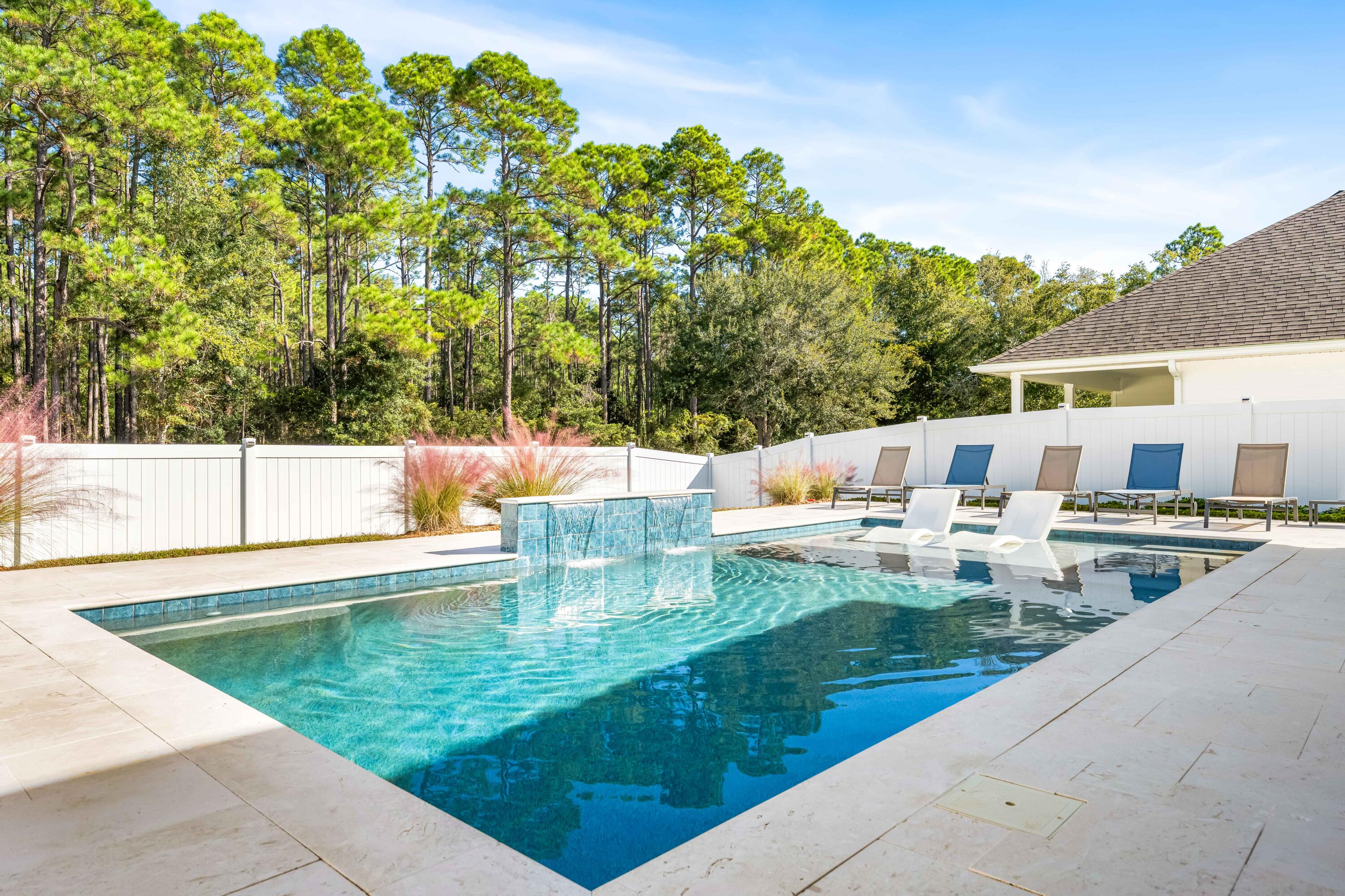 Welcome to one of Walton's Landing's most inviting homes, where everyday living flows effortlessly between indoor comfort and resort-style outdoor living.

The backyard is a true showpiece—an expansive private retreat with travertine pavers, a heated and chilled PebbleTec saltwater pool, and a covered lounge perfect for game days or sunset dinners. The screened porch adds shaded comfort, and the fenced yard offers privacy for pets and play.

Inside, the open-concept layout features quartz countertops, Café by GE appliances, elegant hardware, and luxury vinyl plank flooring throughout. A flexible front room serves as an office or den, while a main-level guest suite and full bath provide ideal accommodations. Upstairs, a spacious bonus room links two bedrooms, with a third guest room and full bath nearby. The primary suite offers a serene escape with double vanities, quartz surfaces, a soaking tub, walk-in shower, and custom Tailored Living closet.

Smart home upgrades include keyless entry, a video doorbell, and touchscreen controls. Built with advanced Zip Sheathing for durability and energy efficiency, this home pairs craftsmanship with coastal sophistication.  All just minutes from 30A beaches.

Community amenities include a resort-style pool, cabana, grilling station, and walking trail.