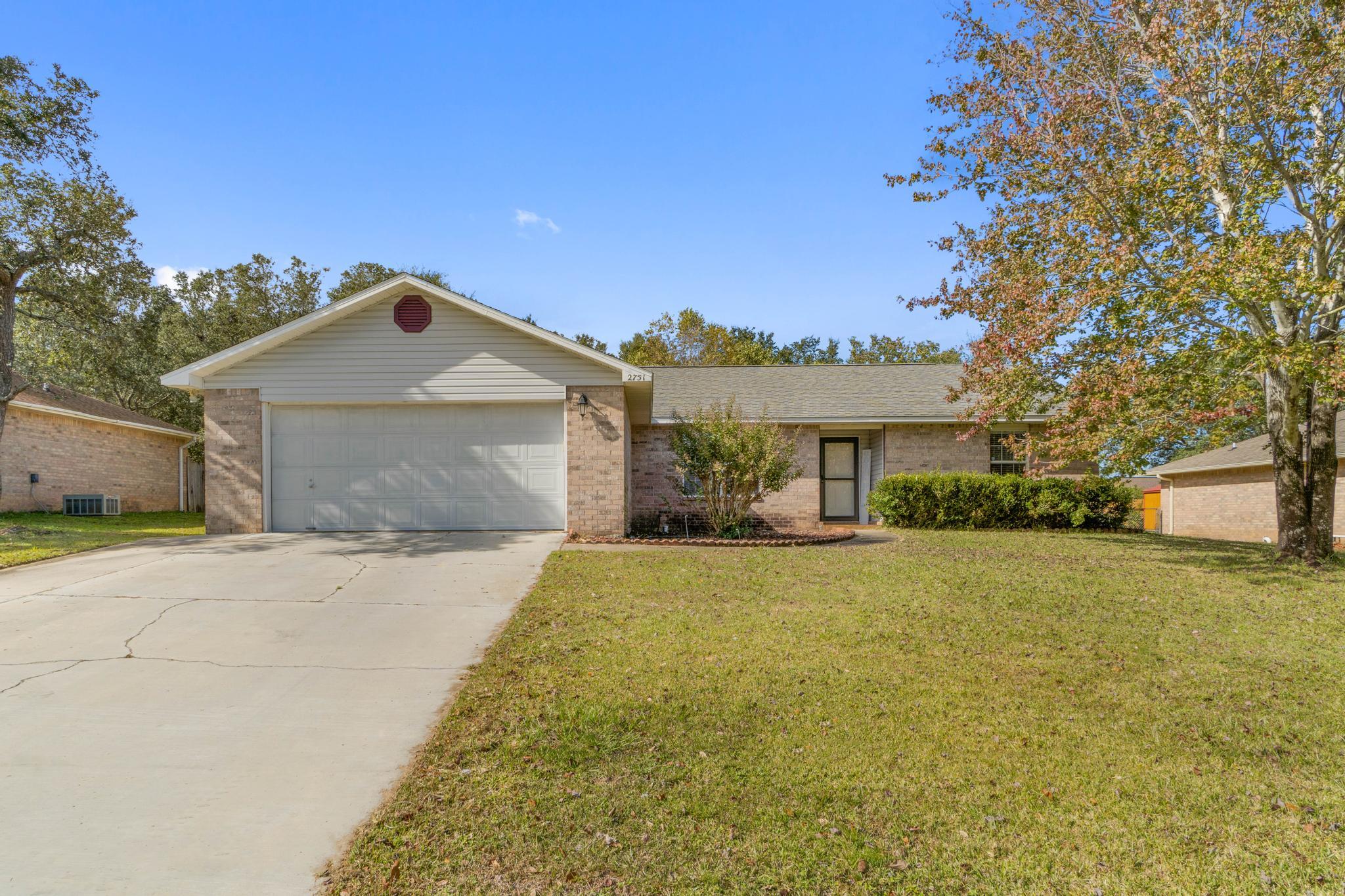 Welcome home to this lovely all brick Navarre retreat on a spacious 0.33 acre lot featuring 3 bedroom and 2 bathrooms with an additional dining room space AND a large screened in patio! Conveniently located off of East Bay Blvd on a street with NO HOA pull into the driveway and you'll immediately love the extended driveway pad for additional parking. Walk into the front door and you'll see this charming home features hard surface flooring throughout with no carpet! The well appointed kitchen has all the space you're looking for with an additional pantry and an eat in kitchen area. The master bedroom leads to the en suite where you'll find double vanities and two separate walk in closets! The other two guest bedrooms have ample closet space and share a bathroom between them. You will LOVE this backyard with plenty of room for pets and kids to play! There's also an additional 16x20 storage building in the backyard within the fully fenced in yard in addition to the two car garage. Appreciate updates like a new septic leach field in 2018, an updated UV filtered HVAC unit, and a solar-powered attic fan with added insulation (which means a decrease in electricity consumption.) Don't delay in coming to view your new home!