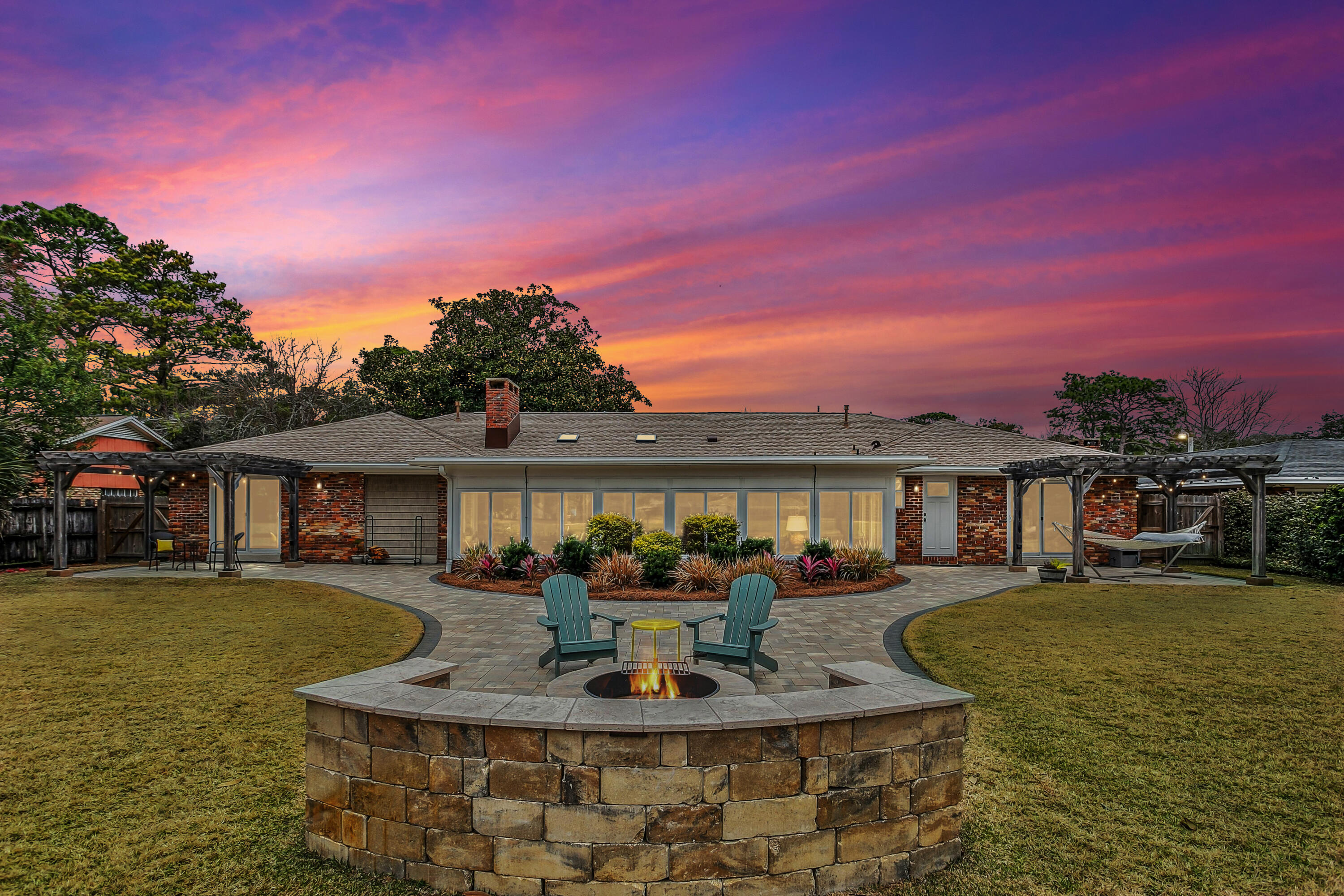 Positioned along the fairway in one of Shalimar's most established golf course settings, 76 Country Club Road delivers refined living with exceptional upgrades and timeless appeal.

This fully reimagined 4-bedroom, 2.5-bath residence offers 3,042 square feet of thoughtfully curated space, including a heated and cooled sunroom designed for year-round enjoyment.

Inside, the kitchen anchors the home with rich custom cabinetry, expansive granite surfaces, stainless appliances, and a generous center island built for both entertaining and everyday elegance. The layout flows seamlessly into light-filled living areas and out to the sunroom, creating a natural extension of indoor-outdoor living.

Every major system has been addressed offering the peace of mind expected in a luxury property. (Comprehensive upgrade list available.)

The outdoor living experience sets this home apart. A professionally installed paver terrace curves around a custom stone fire feature with built-in seating, perfectly positioned to capture tranquil golf course views. Whether hosting guests or enjoying quiet evenings under the sky, the setting is both private and elevated.

Additional features include:
Finished garage with epoxy floors
Custom built-in storage cabinetry
Expansive golf course frontage
Mature landscaping with intentional design

Ideally located:
Less than 10 minutes to Destin-Fort Walton Beach Airport
Minutes to Eglin Air Force Base
A short drive to the Gulf's white-sand beaches

This is not simply a renovated home -- it is a fully updated golf course residence offering enduring quality, intentional design, and a lifestyle defined by comfort and distinction.