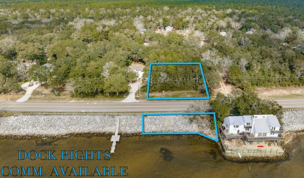 Set along the shoreline of Choctawhatchee Bay, this .78-acre bayfront parcel offers approximately 119' of water frontage and peaceful views toward Miramar Beach. The property features a level building site, mature trees, and natural palms, creating a beautiful natural setting. Dock rights are available, and the parcel is zoned for both residential and commercial use, allowing flexibility for future plans. With on-site drainage and no flood zone designation, the property is well-suited for development. Measuring approximately 216' x 119', the build site is also ideally located less than 5 minutes from the Mid-Bay Bridge, and approximately 10 minutes to Destin Commons and Hammock Bay.

2 parcels: 28-1S-21-41020-003-0110 & 28-1S-21-41020-002-0310

List agent is spouse of the seller