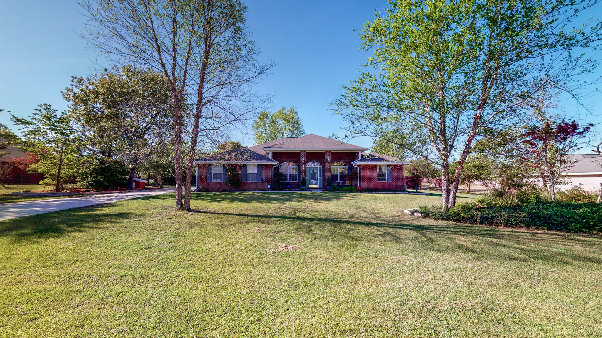 This is it! Welcome home to this 2,336 sq ft, 4 bed/2 bath property that sits on an acre of land in the wonderful community of Mt. Olive Estates. Before you even enter the home, you'll see the beautiful landscaping, pergola, and three separate buildings -- main house with attached garage, workshop/office (that has AC!), and a utility storage building. As you enter the home, you'll notice the slate and bamboo floors throughout as well as plenty of natural light, cathedral ceilings, and a gas fireplace in the main living area. The kitchen boasts new stainless-steel appliances with warranties, a custom wood breakfast bar, custom cabinets with drawers, and a 190 degrees F constant hot water access! Granite counter-tops can be found in the kitchen as well as the bathrooms. The master bathroom... ...has double vanities, and TWO walk-in closets, a separate shower, and a garden tub.  The three other bedrooms are on the opposing side of the house, and two of them offer walk-in closets.  The pergola/screened porch and backyard area are the perfect place for relaxing or entertaining your friends and family with gorgeous views of the citrus trees and wildlife.  As you leave the screened porch, you'll make your way to the 20x32 workshop with roll top door, 220v electric, and finished office area.  Even further back beyond the fenced backyard is the utility storage with covered parking, which can even be accessed through the back road behind the property. Other features to note are the fully operational sprinkler system, solar screens in the windows, installed security system, generator connection point in the garage, hurricane shutters, and a termite bond will convey at closing. Call now for a showing!