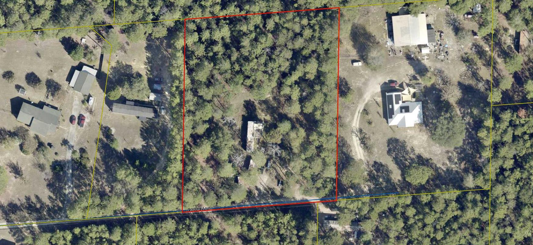 Level 2 acres with lots of trees.  Property will need clean-up.  There are old RV's, mobile home, vehicles that need to be removed by the Buyer.  Seller is not local.