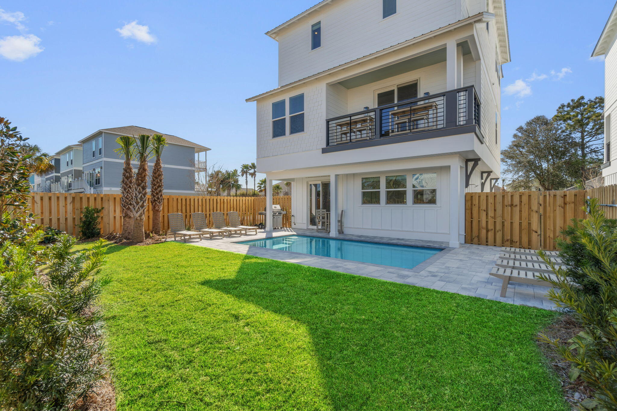 The closest lot to the beach in Blue Ohana, Aquadisiac - 12 N Payne. A ten month old masterpiece designed to deliver a first-class vacation experience. Elevating the essence of modern coastal chic, these residences are masterfully designed to optimize short-term rental returns while offering an unparalleled guest experience. Each expansive 3130 square foot home features 7 elegantly appointed bedrooms, each with its own luxurious ensuite bathroom. The multiple common areas are perfect for entertaining, equipped with wet bars and chef-worthy kitchens featuring high-end GE Monogram appliances, including a gas range and tankless water heaters. 

Professionally curated interiors boast furnishings from Pottery Barn and Williams Sonoma, creating a sophisticated yet inviting ambiance. Outdoors, indulge in the ultimate relaxation with a spacious 20x10 private heated gunite pool that completes this luxurious haven, ensuring an exceptional experience for both investors and guests alike. Projections from $165-180k+ with management in place and ready to go! Now open to show!