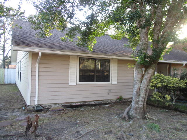 This 3 bedroom 2 bath unit boasts an open floor plan with a large kitchen, ample living room and dining room space. Wood floors in all living areas except for the tile in the kitchen and baths. The kitchen has updated  counter tops and  stainless steel dishwasher and stove. Newer vanity top and sink in the hall bath. Interior laundry room off the hall bath. There is a large fenced back yard for your privacy and entertaining. The driveway is wide enough for 2 cars to park side by side and ample parking available across the street. Call to make an appointment to view today