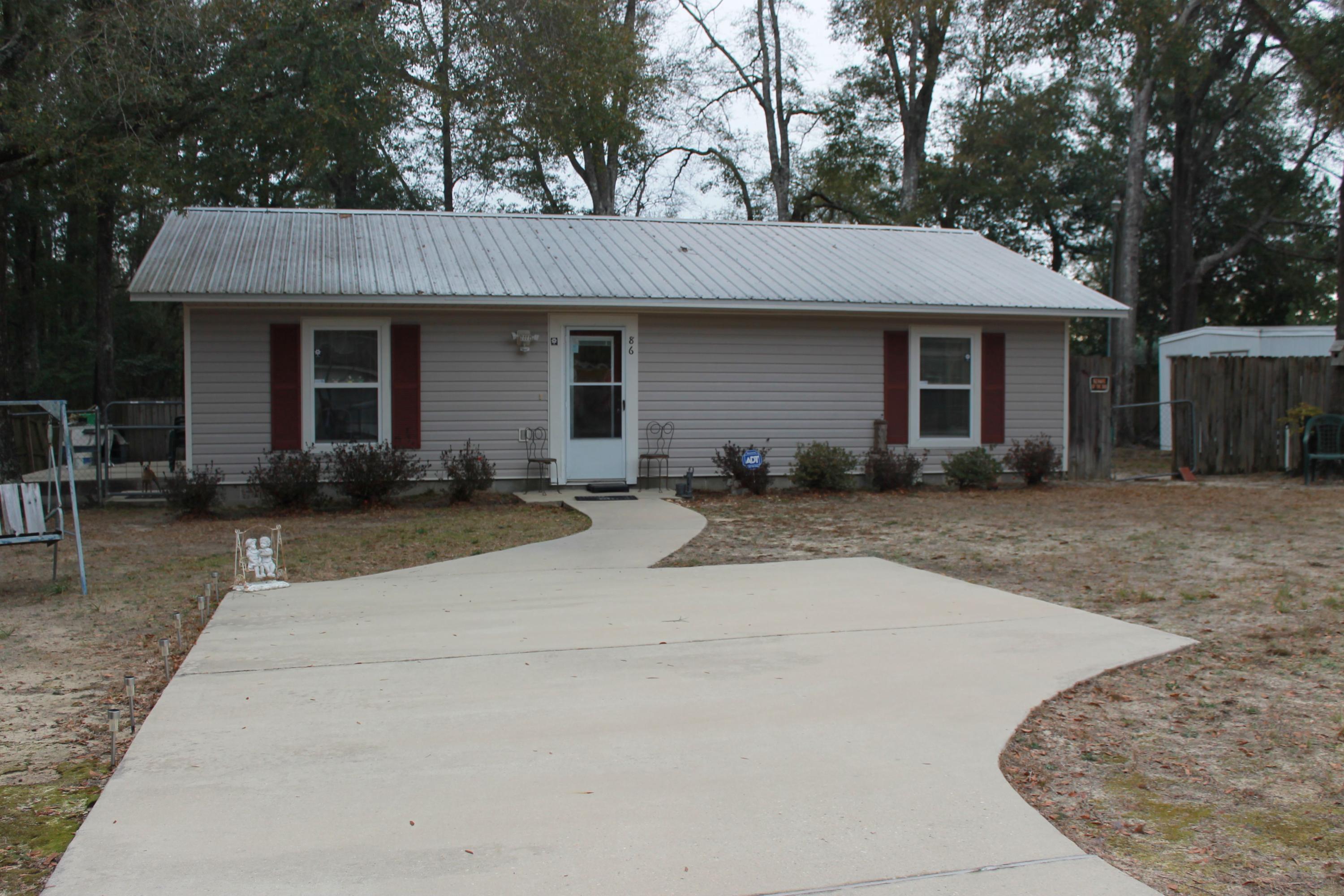 Located inside DeFuniak Springs City Limits. Very close to shopping. Home is very well taken care of. There is tile flooring throughout the house and carpet in the bedrooms. This floor plan features an open kitchen-living-dining area. The kitchen has black Kenmore appliances, custom cabinets, and plenty of counter space with a breakfast bar. The living area has custom recessed lighting. There is a concrete driveway and side porch to entertain. The entire lot is fenced. Home also has a metal roof. Please call to make your appointment today! Buyer must verify all measurements to buyer's satisfaction.