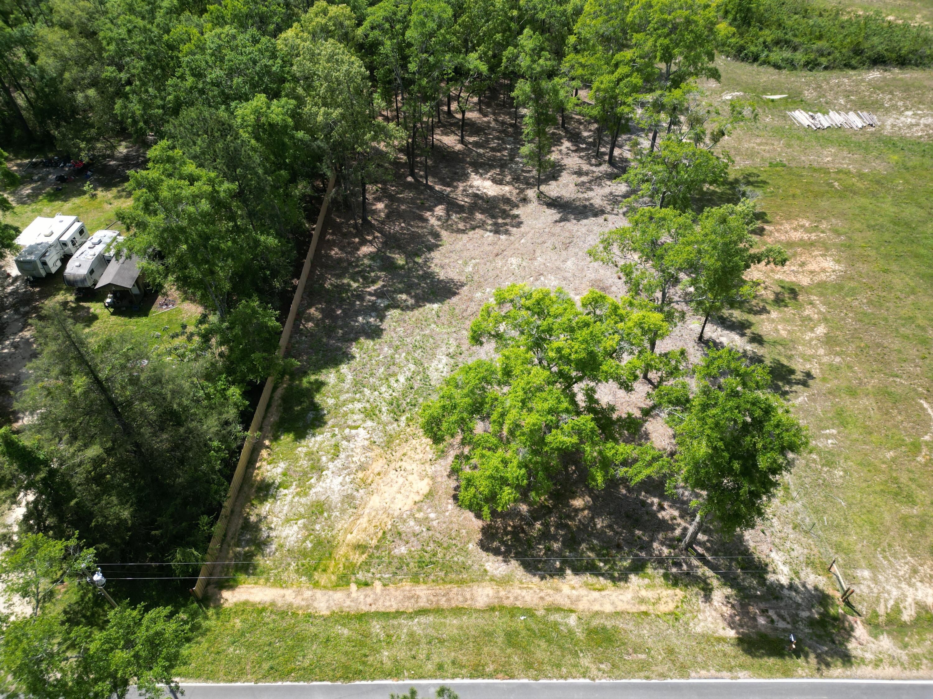 Welcome to Vernon, Florida, where an exceptional opportunity awaits on this sprawling 3.85-acre lot, boasting the perfect blend of nature's serenity and developmental convenience. Situated in a prime location, this parcel of land offers a harmonious fusion of rural tranquility and urban accessibility.

Encompassing 3.85 acres of landscape, this property provides ample space for your dream home. As you explore the grounds, you'll discover approximately 1 acre already cleared and prepared for construction, providing a seamless transition from vision to reality. Imagine the possibilities as you envision your custom-built residence nestled within this picturesque setting.

Lot does not have sewer or water yet but has electric available to hook up. Zoned Agriculture/Silvicultur Lot lines on photography are estimated and may not be exact. Lot lines on property appraisers photo may be more exact.