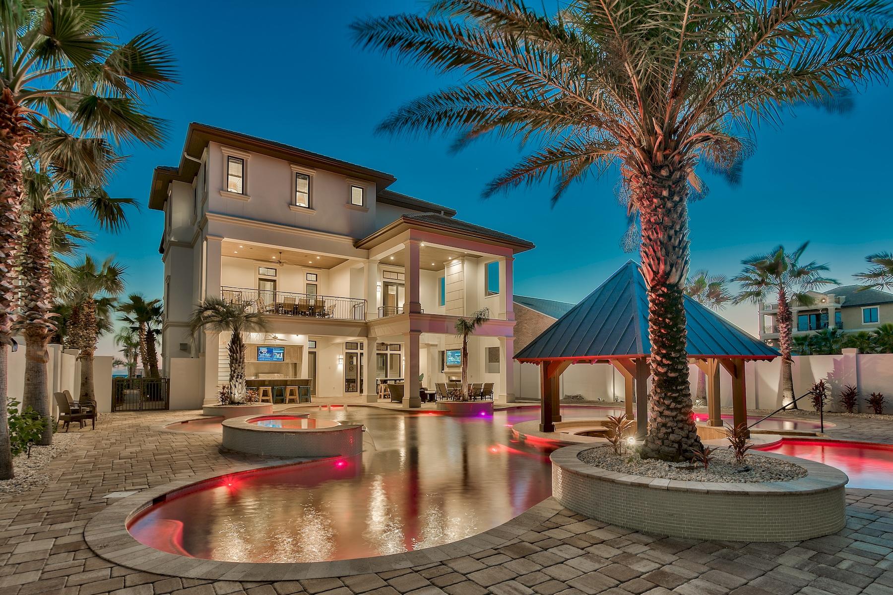 Masterful coastal contemporary residence perfectly situated to capture gorgeous gulf views & thoughtfully configured providing unparalleled amenities including an 80,000 gallon private resort style pool area complete with a sunken swim-up cabana bar as well as an adjoining spa and covered multi-story outdoor kitchen & living space. This property is an excellent income producer with over $374,000 in gross annual rental income in 2017. This home has been recently updated in 2018 to offer an optimal sleeping configuration with the addition of a fourth 3rd floor master suite overlooking the lagoon style pool. The thoughtful layout maximizes functionality while offering finely appointed, chic contemporary finishes with optimal comfort & living space. Notable features include multiple indoor and outdoor living areas, private commercial grade elevator, dual master suites with unobstructed gulf views, built-in pinterest style bunkbeds, indoor and outdoor surround sound system as well as security cameras for optimal privacy. The first floor layout boasts a dual laundry area, two full bedrooms, industrial style game room complete with built in wet bar and full size Viking fridge as well as a large bunk area and two full bathrooms. The second floor is the focal point of indoor living space with a spacious living room featuring floor to ceiling windows to soak in the beautiful gulf views, gas fireplace, built-in entertainment center and open to the massive dining area overlooking the beach. The ample sized kitchen features floor-to-ceiling custom cabinetry, paneled Viking appliances and gas range, walk-in pantry and large center island with gorgeous shell infused custom countertops. The second floor also features two full bedrooms with ensuite bathrooms & half bath as well as access to the second story outdoor dining area overlooking the lagoon style pool. The third floor features 4 full bedrooms including dual master suites, incredible bunk room with ensuite bathroom, dual laundry area as well as wrap around balconies with a fourth story viewing deck to maximize the incredible gulf and lake views that surround this prestigious home. Grand Palms owners enjoy full access to the amenities in the gated community of Destiny West as well as excellent proximity to multiple beach access points surrounding the property.