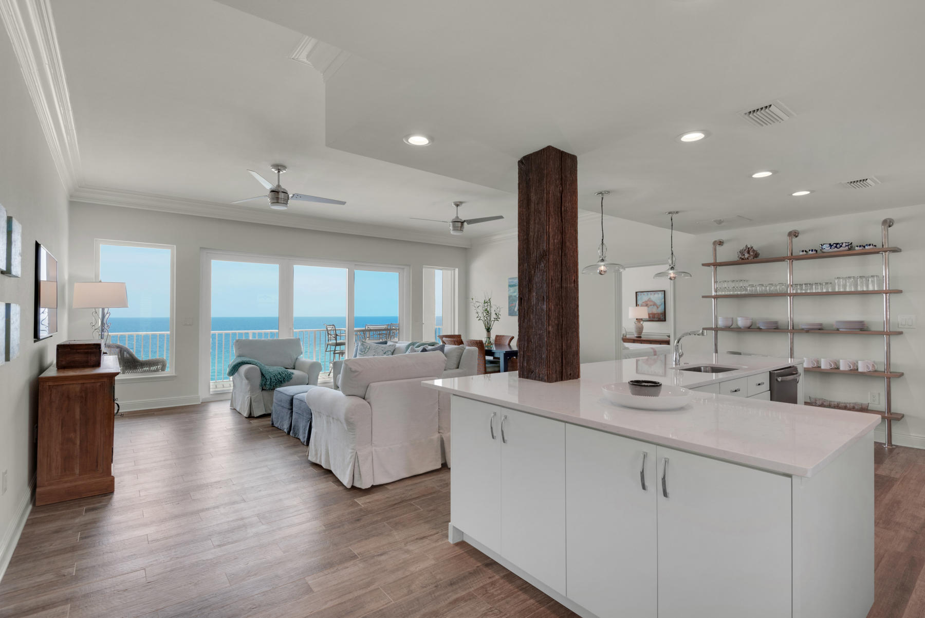 Fully renovated top-floor penthouse with a private 2-car garage in Compass Rose, Miramar Beach/Destin's exclusive condominium community with only 2O units and deluxe amenities. This is a rare opportunity to own a beachfront condo in a rental-restricted building. This 1,619-sqft penthouse features up-to-the-minute coastal interiors, 10 ft ceilings, renovated kitchen/baths, and a large balcony spanning 50 ft long and over 300 sqft. White walls, natural wood accents, and see-through light fixtures allow turquoise waters to take center stage. The all-white kitchen with white stone countertop and rustic wood beam is light, bright, and classic. Both bedrooms face the Gulf and open to the oversized balcony. The master bath is an at-home spa retreat with soothing materials and luxury finishes. High quality glass hurricane rated windows and doors installed in 2016 and new A/C installed in 2018. This home also includes 2 large storage units - one by the beach and one near the garage. Stylish furnishings convey in sale. Compass Rose offers a rooftop deck with seating, seasonal beach chair service, gym, media room, and beachfront deck.