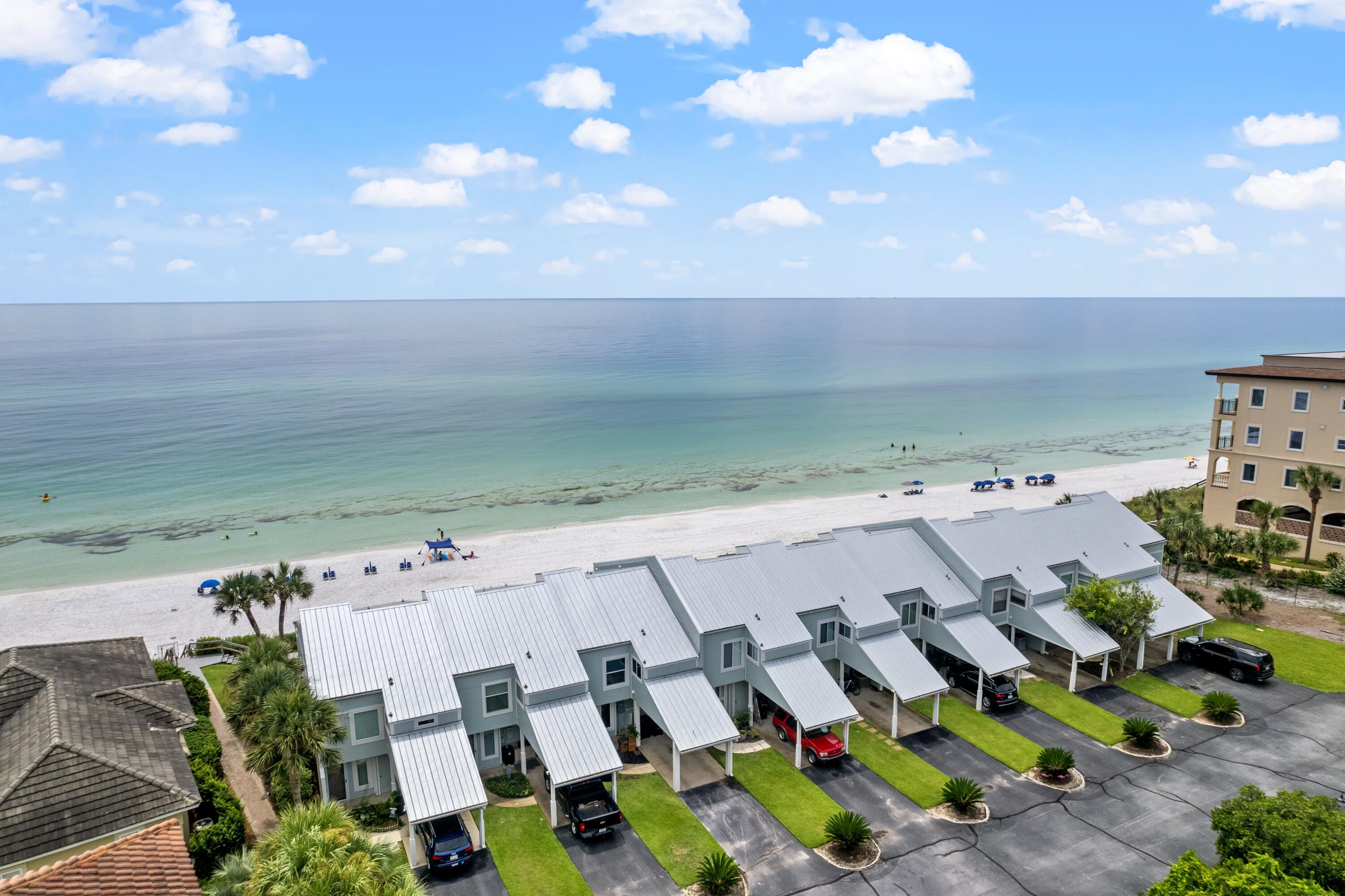 Positioned Gulf front on an elevated bluff within the intimate Sea Cliffs community, this ground-floor residence offers sweeping Gulf views, deeded beach ownership, and a proven income profile with over $113,000 in rental revenue generated in the most recent year. One of only nine residences, it presents a rare blend of privacy, prestige, and investment appeal.

The thoughtfully remodeled interior is offered with desirable furnishings and features an open-concept living area designed to capture the Gulf views. The kitchen opens seamlessly to the living and dining spaces, anchored by a spacious island and stainless steel appliances ideal for everyday living and entertaining. A wet bar located just off the kitchen enhances functionality and guest convenience. Gulf-facing windows flood the living area with natural light and sweeping water views, complemented by clean, neutral finishes throughout.

The Gulf-front primary bedroom opens directly to a private patio with privacy dividers, offering an ideal setting for morning coffee or sunset views over the water. Ground-floor living, covered carport parking, and additional on-site parking further enhance ease of access for owners and guests alike.

With a strong rental history and a boutique Gulf-front setting along 30A, this residence presents a compelling opportunity for buyers seeking coastal elegance paired with reliable income performance.