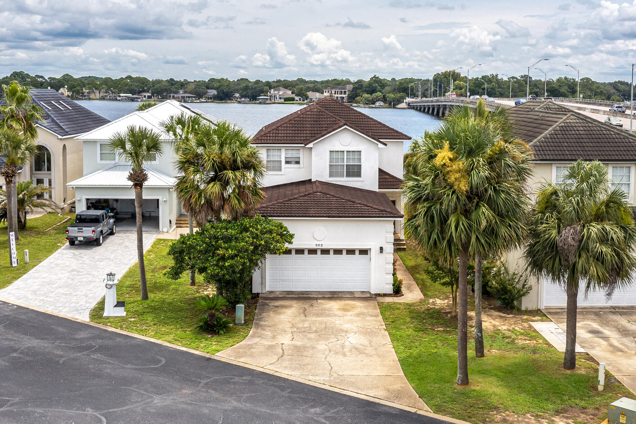 Waterfront property in Lighthouse Point sits on the Bayou off Choctawatchee Bay.  This spacious, 4 bed, 3 bath home is open and bright with water views the moment you walk in.  Upstairs there is an Oversized Master Suite that overlooks the water, with a huge walk-in closet, tile shower and double vanity with tons of cabinet space.  There are also 2 additional bedrooms and a full bath.  On the main level there is a second Master Suite Option.  There is a private dock with a boat lift, perfect to take your boat on a short trip to the nearby waterfront restaurants and Crab Island.