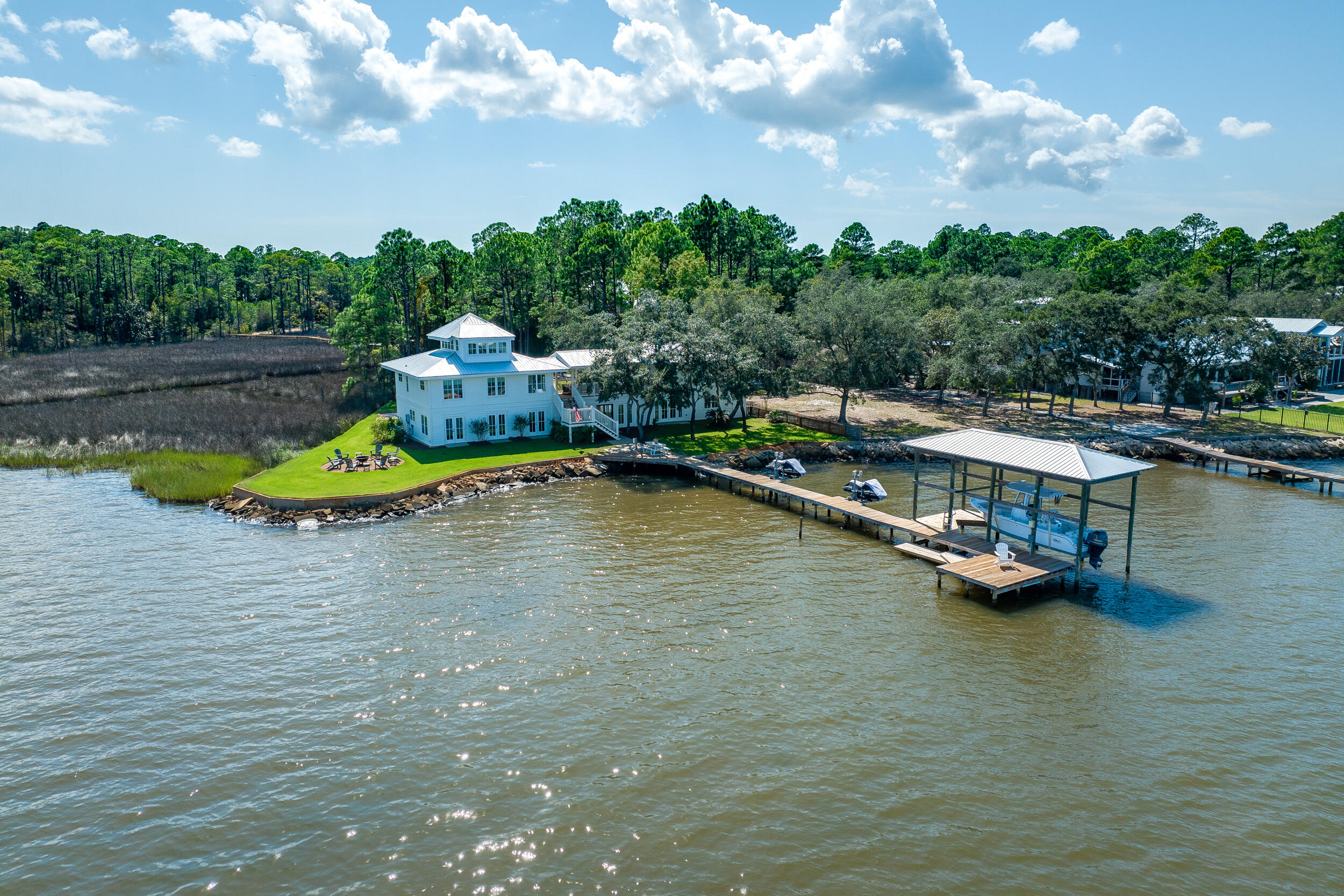 Nestled along the shores of the Choctawhatchee Bay, this extraordinary bayfront home has been completely reinvented and reimagined to offer the epitome of coastal luxury living. With an impressive 147 feet of pristine bay frontage and a spacious 3,934 square feet of living space, carriage house included, this property is a true coastal gem. Situated on a private corner lot, it boasts panoramic bay views that will take your breath away. Thoughtfully designed with modern luxury to include, high-end finishes, top-notch appliances, and a spacious layout. With 4 bedrooms, 4 1/2 baths plus loft, this home provides ample room for both relaxation and entertainment. The carriage house adds a touch of charm and versatility to the property, suitable for guests, a home office, or a studio. Relax on the courtyard patio, porch or on your private dock for gorgeous sunrises and sunsets. Don't miss the chance to make this exquisite property your own. Buyer to verify all measurements and important information