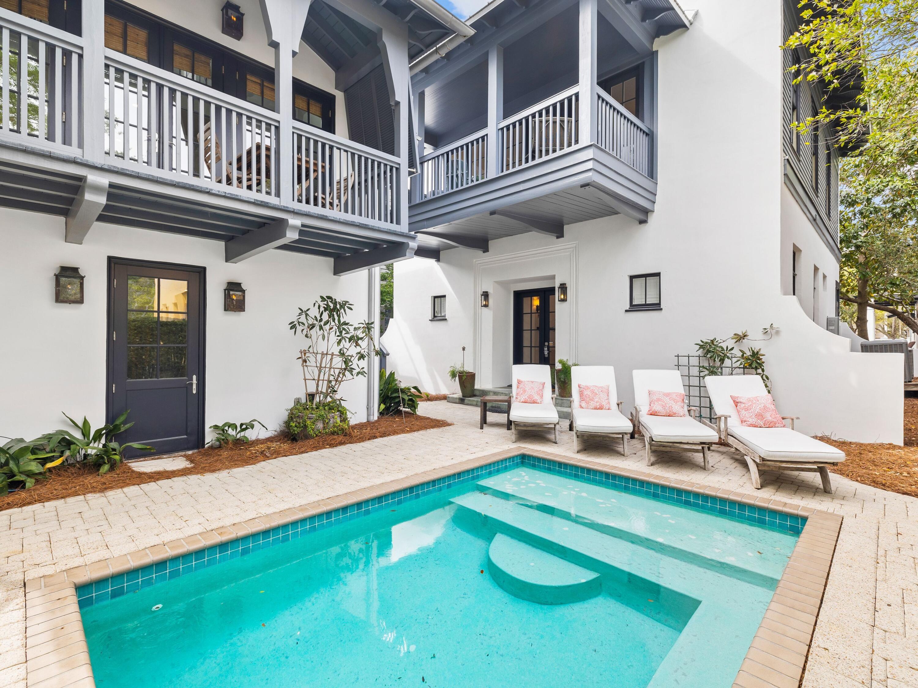 Step inside a realm of elegance at this luxury enclave that comprises a beach cottage and a carriage house that can be rented separately. Renovated by Tracery Interiors, this exclusive Rosemary Beach residence is tailor-made for those looking for luxury, convenience and tranquility. Arranged around a peaceful courtyard with heated pool, the newly painted main house has two updated master suites and a bunk room on the first floor with beautifully curated living space above. The great room is bright and open with rich hardwood flooring and a plethora of windows introducing an abundance of daylight. It seamlessly segues into the magnificent chef's kitchen which is fully equipped with Signature appliances including the fridge, stove, microwave and dishwasher. Custom cabinetry and waterfall quartz countertops enhance this practical open space. A row of stools is lined up at the quartz-topped island where leisurely breakfasts and evening cocktails can be enjoyed along with social conversation. The formal dining area is perfect for entertaining beneath a glittering chandelier. Open the French doors for access to one of several covered balconies enjoying different perspectives of the turquoise pool, landscaped courtyard and neighborhood green. It's a secluded haven for reading and sunbathing after a morning stroll on the nearby white sandy beach. New tile, light fixtures and renovated bathrooms give this home a brand-new finish along with new beds, rugs and lamps. The separate carriage house is equally impressive with a lofty foyer and fresh decor. It is luxuriously equipped with new appliances in the well-appointed kitchen. The main floor features comfortable living space and a full bathroom, with the loft bedroom and ensuite bathroom on the upper mezzanine beneath the soaring cathedral ceiling. This beautiful home is superbly located just a one-minute stroll to the beach walkover and Coquina Pool. The two-car garage offers secure off-road parking and a secondary washer and dryer. Not surprisingly, this upscale property has a strong rental history in past years.