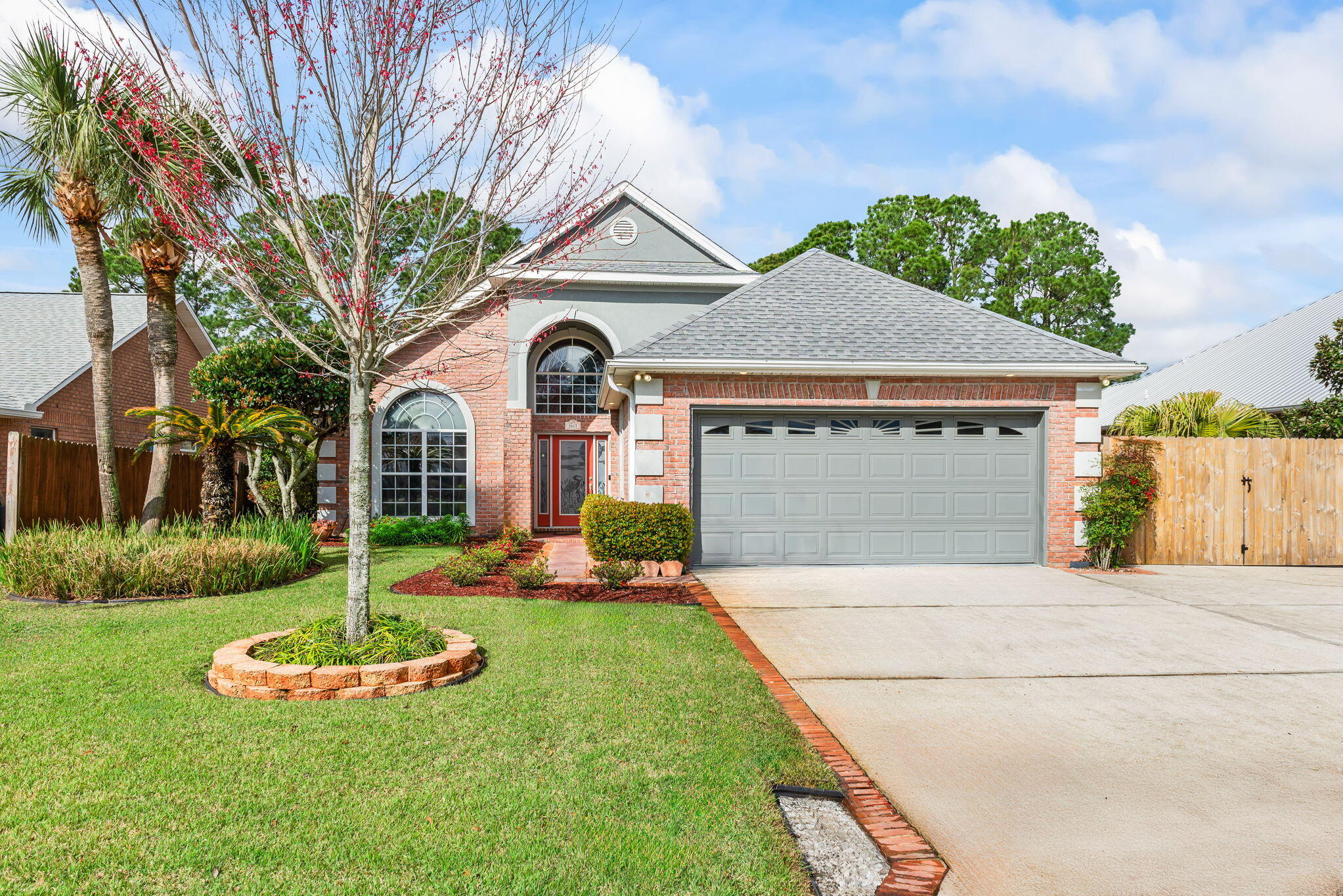 **IMMACULATE Canal Waterfront Home in Polynesian Islands, Gulf Breeze**Welcome to your dream home! This stunning 4-bedroom, 2-bathroom WATERFRONT property offers everything you need for luxurious living. The split floor plan begins with a grand foyer, leading to spacious living areas ideal for entertaining. Upon entering, you'll appreciate the open layout featuring a cozy gas fireplace in the living room, wired surround sound, and elegant plant ledges. The MODERN Kitchen is a chef's delight with granite countertops, cherry-stained alder wood cabinets, a custom backsplash, and a large pantry complemented by black appliances. The master suite is a true retreat, equipped with an ensuite that boasts a luxurious jacuzzi tub, an oversized vanity, and a cultured marble shower featuring dual dual shower heads. Each of the three additional bedrooms offers ample space, making it perfect for family or guests. Step outside to your own paradise! Enjoy the screened back porch overlooking the 70 ft of canal frontage with deep-water access to Pensacola Beach and the Gulf of Mexico. The property includes a boathouse with a lift, a seawall, and extensive landscaping showcasing mature trees. Additional amenities include a 2-car garage, an oversized driveway with enough space for a boat trailer or RV (behind the privacy fence), blown cellulose insulation, and 2x6 construction for energy efficiency. Recent updates include a new roof (June 2020), HVAC system (April 2020), and hot water heater (October 2009). This home is not just a residence; it's a lifestyle. Don't miss the opportunity to make this exquisite property yours!