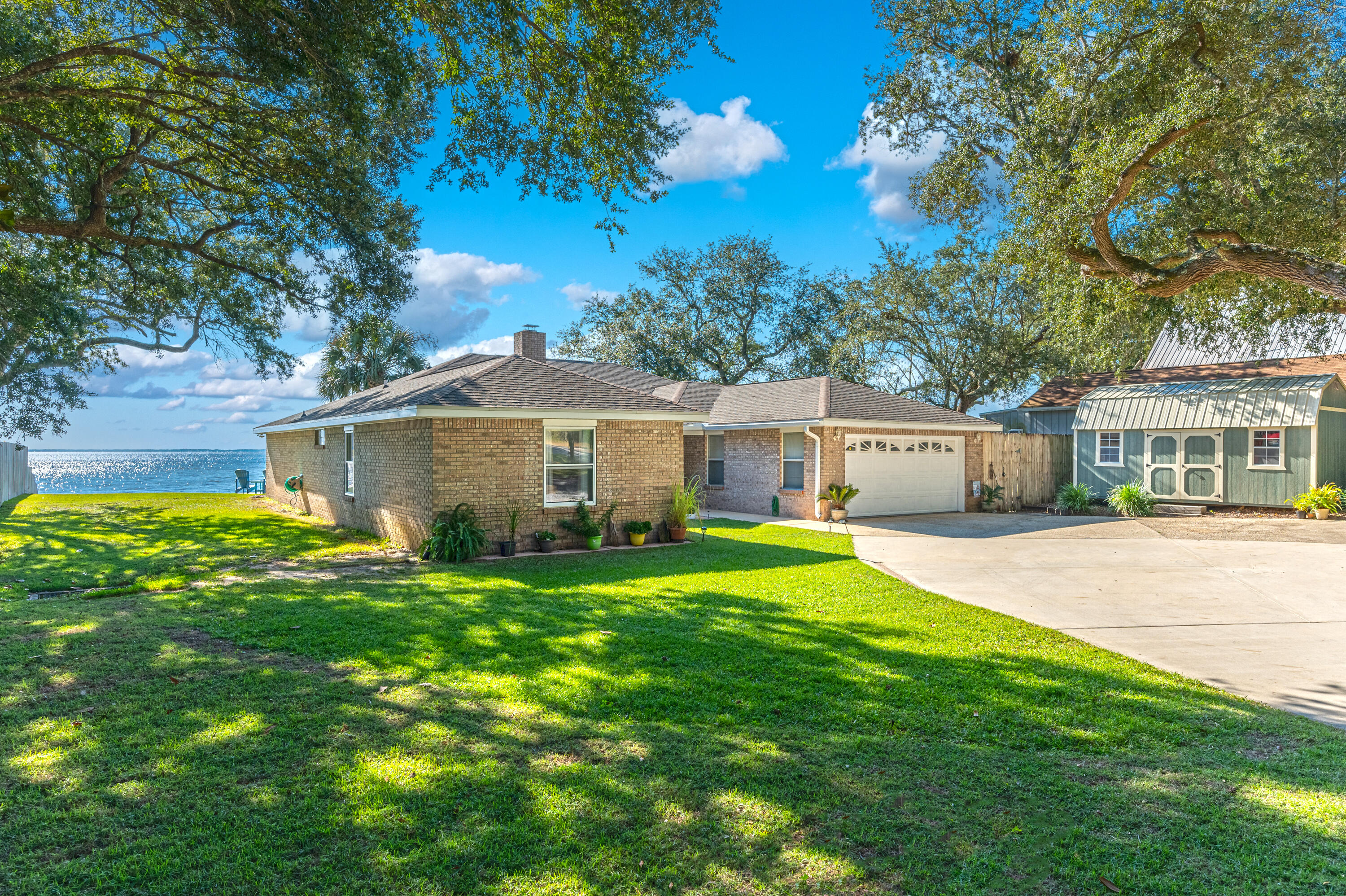 Once Upon A Time, and Happily Ever After! This could be You. Are you ready for easy living at its best? Look no further and get ready to relax in style. This home was not spared any expense in making it ready for the next Owners. With views and sunsets that can leave you breathless, this home comes equipped with a  4,000 lb twin motor 240v dual control boat lift, 55 tons of rock brought in to reinforce the seawall, fish cleaning station directly off the dock, a driveway that can park 17 vehicles, and No that is not a typo, and the list goes on. Upon entry, you have a formal living to your left and formal dining room to your right. As you enter the Den, you are greeted with vaulted ceilings, a double-sided fireplace, and views galore of the expansive yard and Choctawhatchee Bay! There is an enclosed Florida Room that is perfect for those rainy days to enjoy the view. Under the roof, you have 3 amazing size bedrooms, with the Primary Suite nestled on the Bay side to capture those beautiful sunsets. This bedroom has its own en-suite bathroom with double vanities, dual walk-in closets, and a stand-alone shower. Walk down the hall-way and you will find the other two bedrooms plus the 2nd full bathroom, complete with a whirlpool tub/shower combo. Did we mention fishing? This is also an Angler's paradise, or Angler in training with the amount of fish that can be caught from your private dock alone. This home is ready for new Occupants and will not last long, so make your appointment and take a look at this one before someone else makes the catch of a lifetime!