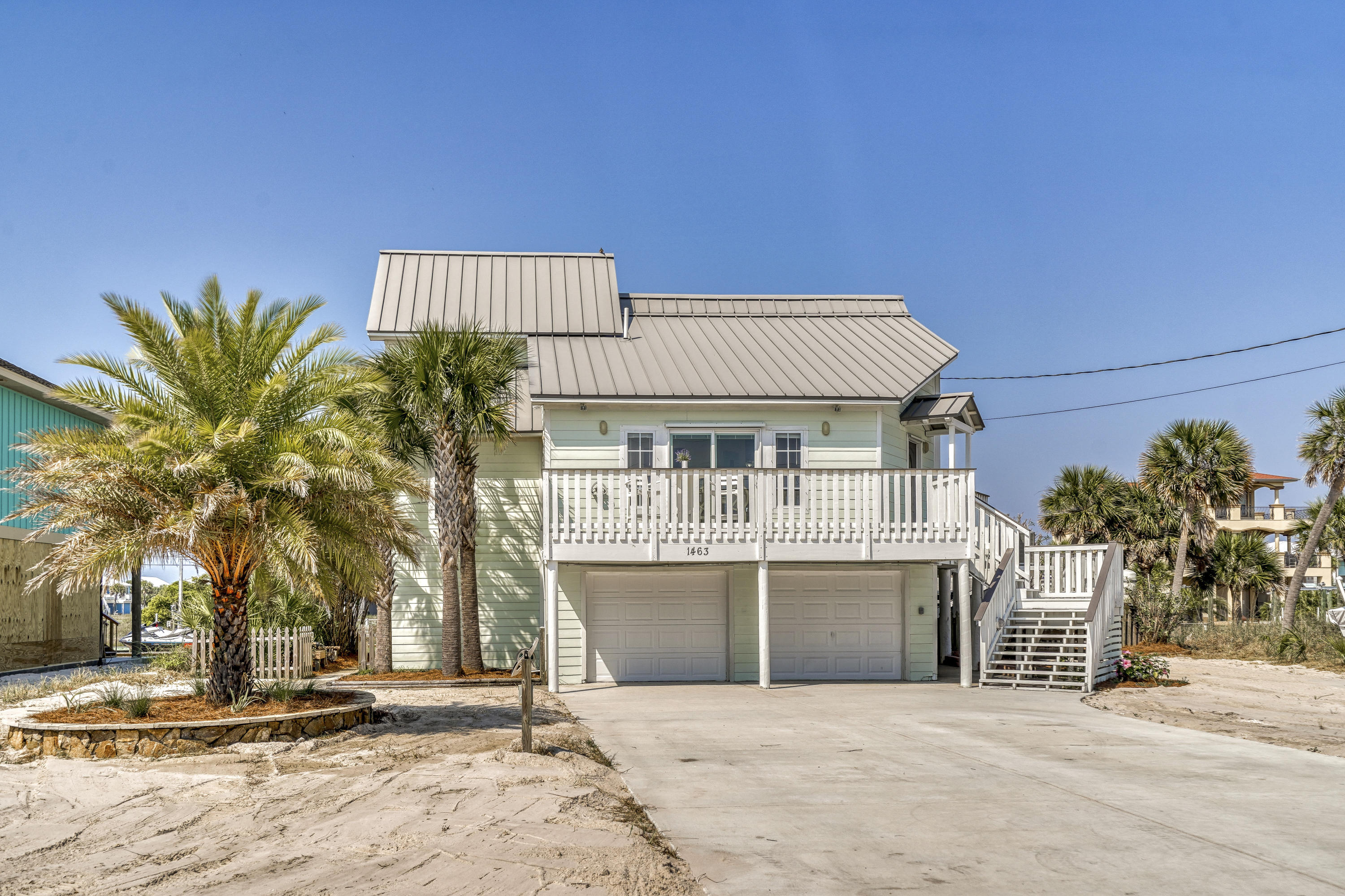 Gorgeous WATERFRONT, Deep Water Canal Home with 80+ Feet of Frontage, Seawall, a Gunite Saltwater Pool, 10K lb Boat Lift & Davit Crane, no HOA, and Panoramic Views of the Santa Rosa Sound! This 3 Bedroom/2 Bath Home is Perfect for the Boating and Water Activity Enthusiast. As soon as you enter, you'll feel the openness the Main Level provides, with Tall Cathedral Ceilings, Open Living & Dining and Tons of Natural Light. This wonderful home was Meticulously Maintained and boasts Updates galore, such as Newer Dock and Dishwasher in 2017, New HVAC Smart System with Sensors and Dryer in 2019, and New Driveway, Pool Pumps, and Landscaping all in 2020. The Kitchen / Dining Area has new low E High Efficiency Sliding Doors, Walk-in Laundry Closet, Spacious Pantry with Built in Cabinetry... ..& Shelvingand Stainless Appliances. 

The Back Yard is an Oasis sitting on one of the Widest Beach Canals, with Lush Tropical Landscaping, Newer Composite Dock, Gunite Saltwater Pool equipped with Lighting & Waterfall, Outdoor Shower, Covered Massive Patio on the Ground Level, and Expansive Composite Railing and Decking on the Main Level overlooking the Canal and Santa Rosa Sound. Right from there you have your 10K pound Boat Lift, Davit Crane, Jet Ski Holding Fixtures, and a pass-through Garage for ease of Jet Ski towing. It's an Amazing Place you have to see and experience for yourself, where you'll see unforgettable sunrises and sunsets. 

The front of the home has a Sizable Deck with Santa Rosa Sound Views, an oversized Driveway with plenty of Parking for RV with RV Hookup, Toys, and Vehicles, and the steps leading up to the main level are very wide with built-in lighting. The Garage has Space for two Cars plus Space for Family Sized Golf Cart and comes with an Enclosed Bonus Room, currently used for workout / game room, and Built-in Shelving & Work Bench. The entire yard is bordered with 12 Mature Palm Trees, comes sodded in the rear and is perfectly Beach-Landscaped with Irrigation System for ease of Maintenance. 1463 Arkansas comes with a 50 Year Standing Seam Metal Roof and Hardi-Plank Siding for easy and a durable beach home.

Additionally, there are Tiled Floors and Recessed Lighting throughout with plenty of Extra Storage areas in the Living Area and under the Stairwell. Every Room of this Magnificent Home has Views of the Santa Rosa Sound and Canal. Positioned near the Cul-de-sac it's location provides a more private feel and Quite Street. This home was not used as a Vacation Rental and has Been Very well Maintained and Loved.  It would also Make a Perfect Secondary Home/Vacation Getaway. 

Navarre Beach is one of the last places with the old Florida feel and has been coined "Florida's Most Relaxing Place."  There's so much to do right from your Home and Backyard or go explore and enjoy additional Leisure on Florida's Longest Fishing Pier, visit the nearby Parks, hiking/biking trails, or relax on the Gulf of Mexico's White Sandy Beaches with Emerald Hued Waters. Navarre is also home to one of the most Gorgeous Stretches of unaltered beaches in the world at the Gulf Islands National Seashore. Don't miss this Fantastic Opportunity to Own a Piece of Paradise!