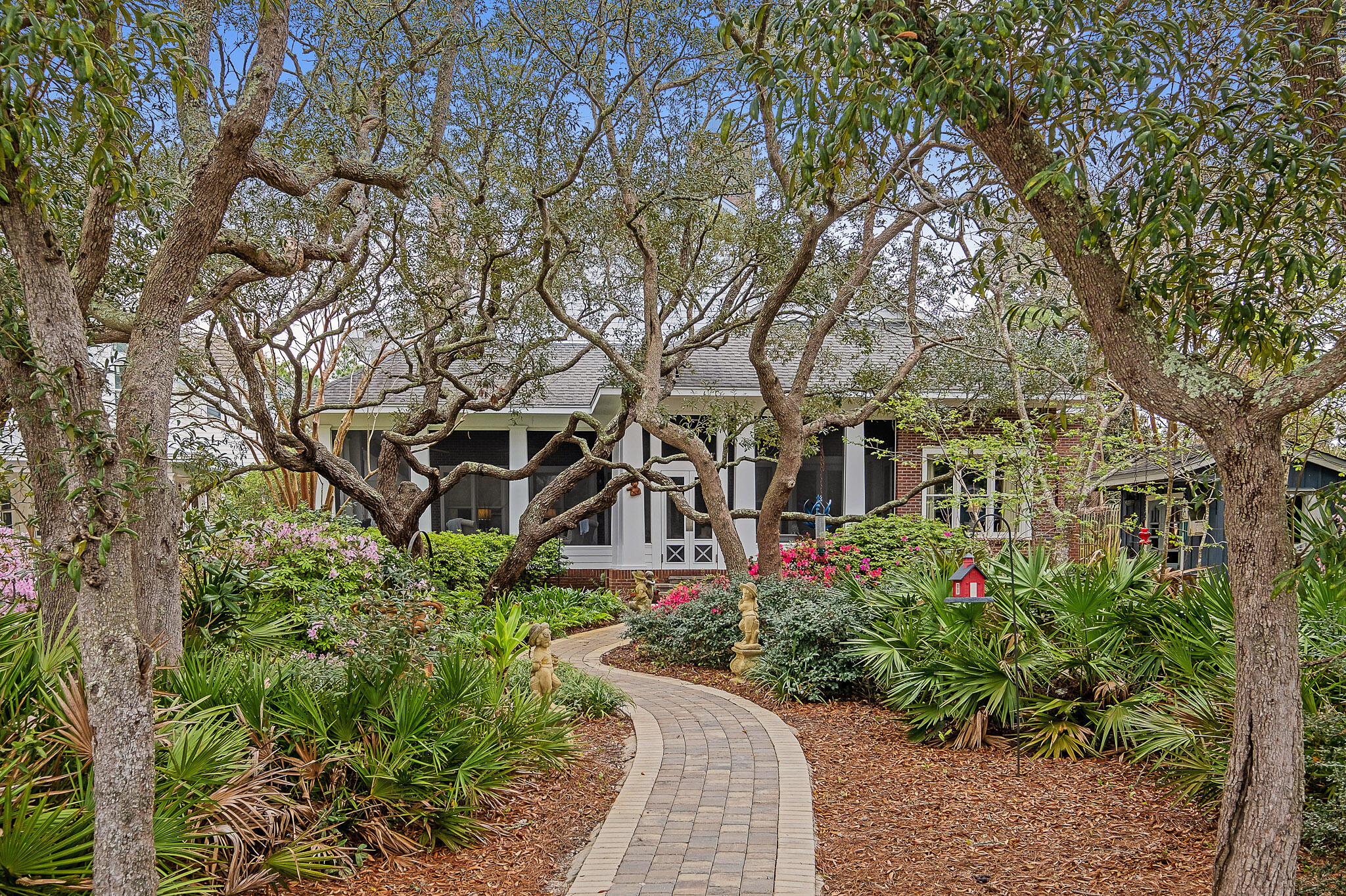 The true epitome of bayfront living awaits you in this stunning New Orleans inspired home off of Mack Bayou. Surrounded by the serenity of the live oak canopy, the backyard sets the stage for westward facing sunsets overlooking the peaceful waters. Ideal for boaters and fisherman alike, Mack Bayou has some of the deepest water available in South Walton, allowing for the mooring of larger boats than most of the surrounding bayous.  The dock includes an approx. 20' covered slip with lift, fish cleaning station, multiple jet ski lifts, and pilings in place on the side slip for a larger vessel. While entering the property, you are greeted with a 3 car garage that includes a large finished carriage/apartment above with spacious open floorplan kitchen/living room, plus a large Bedroom and bath. Moving to the main dwelling you are welcomed with a columned wrap-around porch, reminiscent of old southern living. Designed to impress, the entry door is a reclaimed wooden door from France adding to the character of the home. The main level invites you in with high ceilings, reclaimed wood flooring and a spacious floor plan. The main level contains a waterfront master suite, complete with a living area/office area plus a fireplace. Speaking of fireplaces, there are 4 in this gorgeous home! In addition to the master suite, you will also enjoy an additional guest bedroom, formal living room facing the water, spacious kitchen, den (can be formal dining), powder room, laundry area, and office nook complete with a doggie door and dog washing station. The main level is accented by solid wood doors and the reclaimed wood floors. Making your way upstairs can be via the 2 stop elevator, or the beautiful stairs. Heart of pine flooring greets you upstairs and compliments the 2 bedrooms, connecting bath, and exterior covered deck. (note: one of the bedrooms is currently being utilized as a study and the closet for this room is a huge walk-in just outside the door entry). Enjoy the easy maintenance of owning an all brick home. The back porch is truly a place you will never want to leave. The screened porch for shelter from the sun, rain, and year-round enjoyment all while maintaining the ambiance of lush landscaping overlooking the water. You will also find an outdoor shower and gardening shed in the back yard. Mack Bayou feeds in to Hogtown Bayou which opens to the Choctawhatchee Bay. It provides a year round fishery for redfish, trout, and other species. From Baytown to Crab Island, other boating activities are within short to reasonable distance. This home is located just minutes from Sacred Heart Hospital, Grand Boulevard, Topsail Hill State Park, and the beaches of 30A.