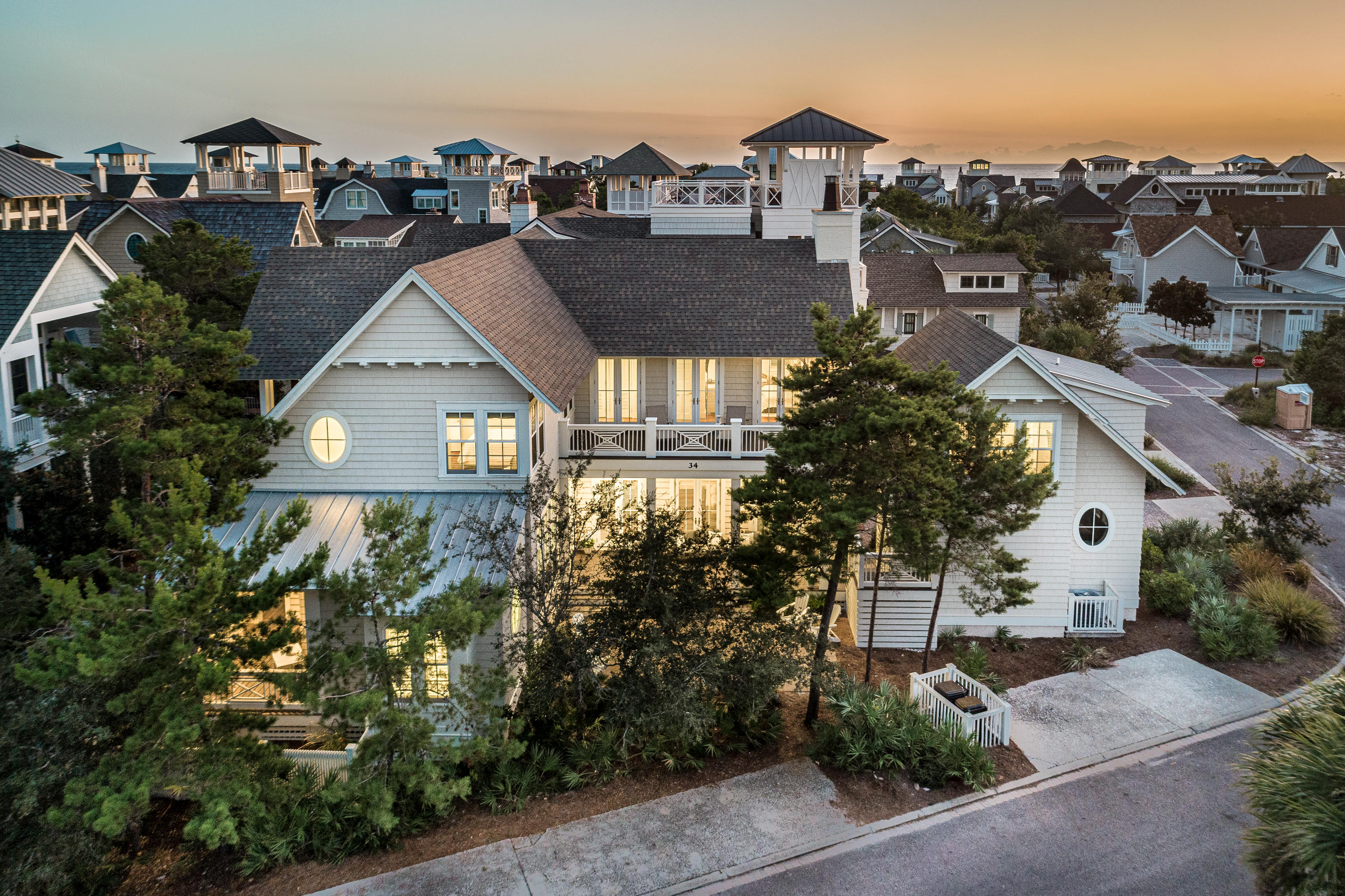 This incredible Watersound Beach home offers 3,499 sf of beautifully designed living space including 4 bedrooms, 4.5 baths in the main house, 2 living rooms. The home's carriage house sits atop it's 1.5 car garage and includes another bedroom, full bath and wet bar! Upon entering the home you will notice the 12 ft ceilings, and eye-catching hand-scraped oak flooring. The kitchen is finished with Thermador appliances and marble countertops, and the home's fireplace, coffered ceilings and shiplap accents add texture and warmth to the main living area. Also found on the main level are a powder room, laundry facilities, and the first of 2 master suites. This master's ensuite bath has a stately oval window separating the 2 vanities, and marble covers every surface. The second level of the home holds 3 more bedrooms, each with ensuite baths, a second living space and soaring vaulted ceilings. This home has never been rented, and has been beautifully finished, professionally decorated, and well-maintained.