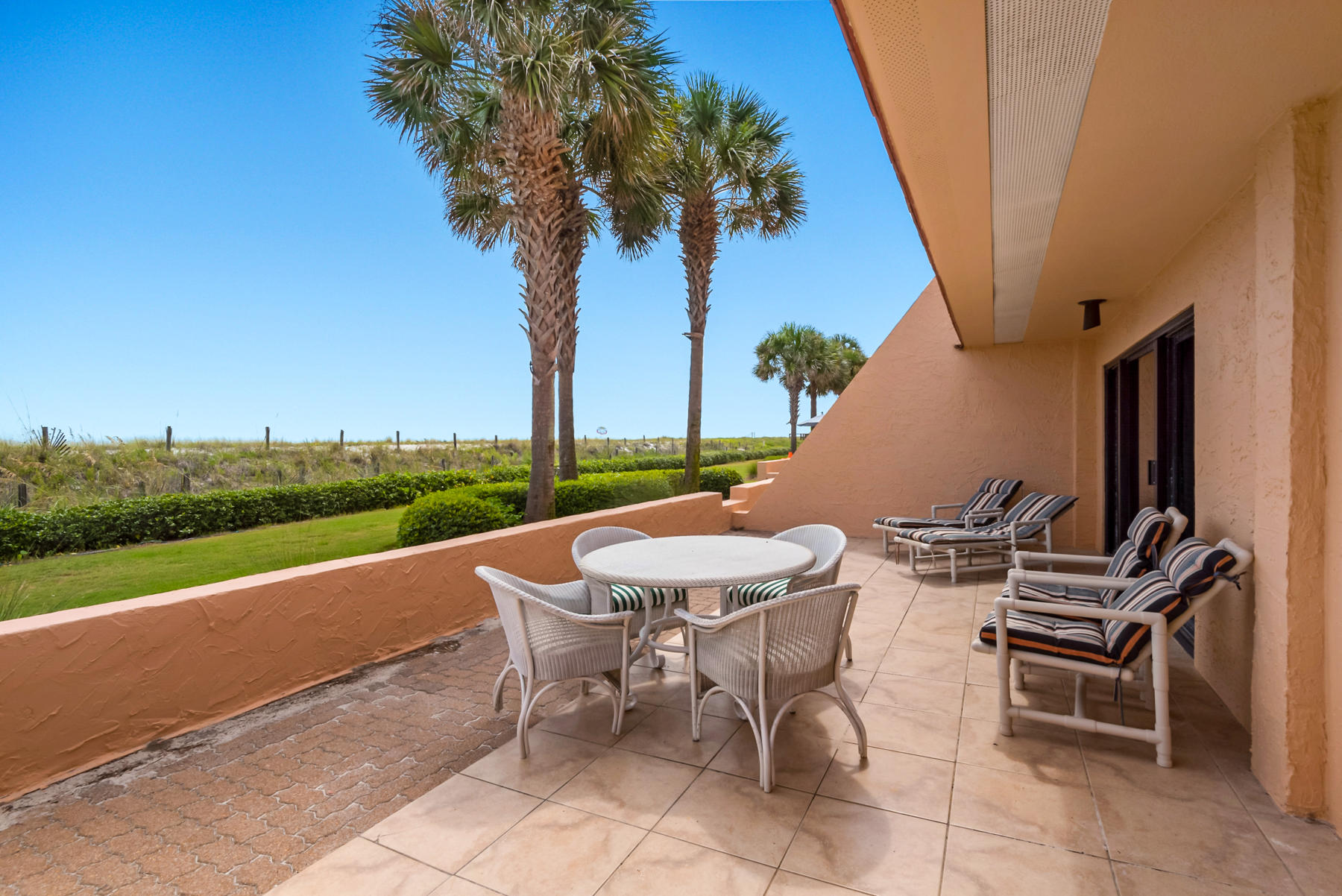 Updated ground-floor beachfront condo with a spacious private patio, upgraded coastal interiors, and entry into exclusive amenities. The Aegean is a gated, amenity-rich, low-density (80 units) beachside condominium community located on Destin's famous 3-mile-long peninsula, Holiday Isle, acclaimed for its direct access to the Gulf of Mexico, Crab Island, and the Destin Harbor. The Aegean's lush, tropical grounds include a private pool, tennis, pickle courts, gazebo, grilling station, and 525 feet of private beach access. Unit 105 is only one of ten ground units located directly on the Gulf. Sea-inspired colors, an open floor plan, and travertine tile floors are on-trend with coastal design. This is an excellent opportunity to own income-producing property. Exceeded $36K income in 2019.