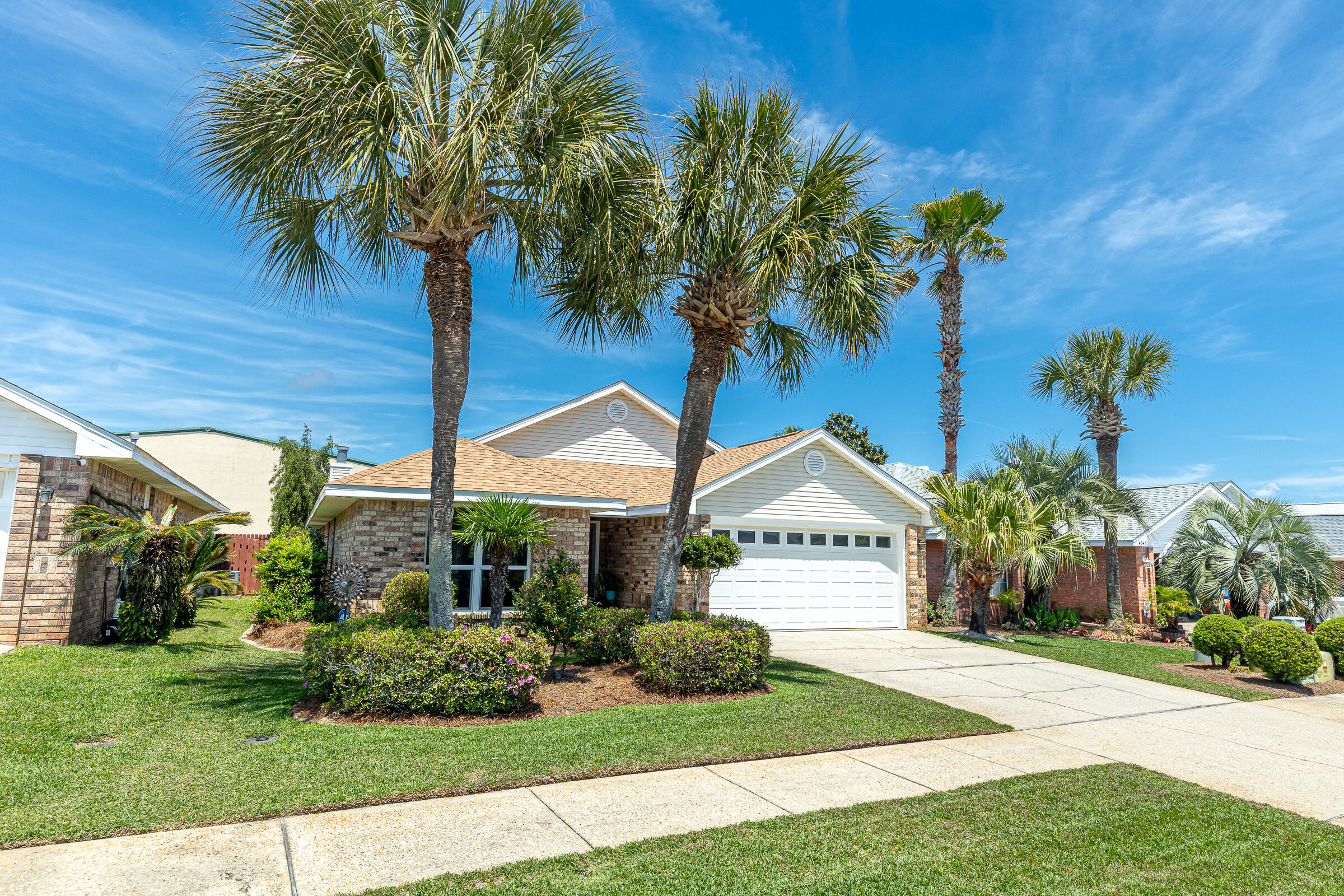 Welcome to Sunsail, a charming, golf cart-friendly neighborhood with a community pool and positioned less than five minutes from The Destin Commons, Publix, and Regatta Bay Golf Course. You're only a few blocks from multiple beach access points including the new $16M Tarpon Beach Park, making this home a perfect vacation rental or a primary residence. This single-story, all-brick home with a fenced back yard offers major updates including a new roof and fascia (2021), R-40 attic insulation (2022), and hurricane-impact windows, doors, and an updated garage system. The HVAC ductwork was professionally sealed with Aeroseal in 2022 for improved efficiency. The kitchen features stainless steel appliances, including a gas range with overhead vent. Enjoy 2 living areas, one with a cozy fireplace! The home has been meticulously maintained with regular AC servicing, dryer vent cleaning, termite protection through Centracon, as well as ongoing pest control and lawn care.