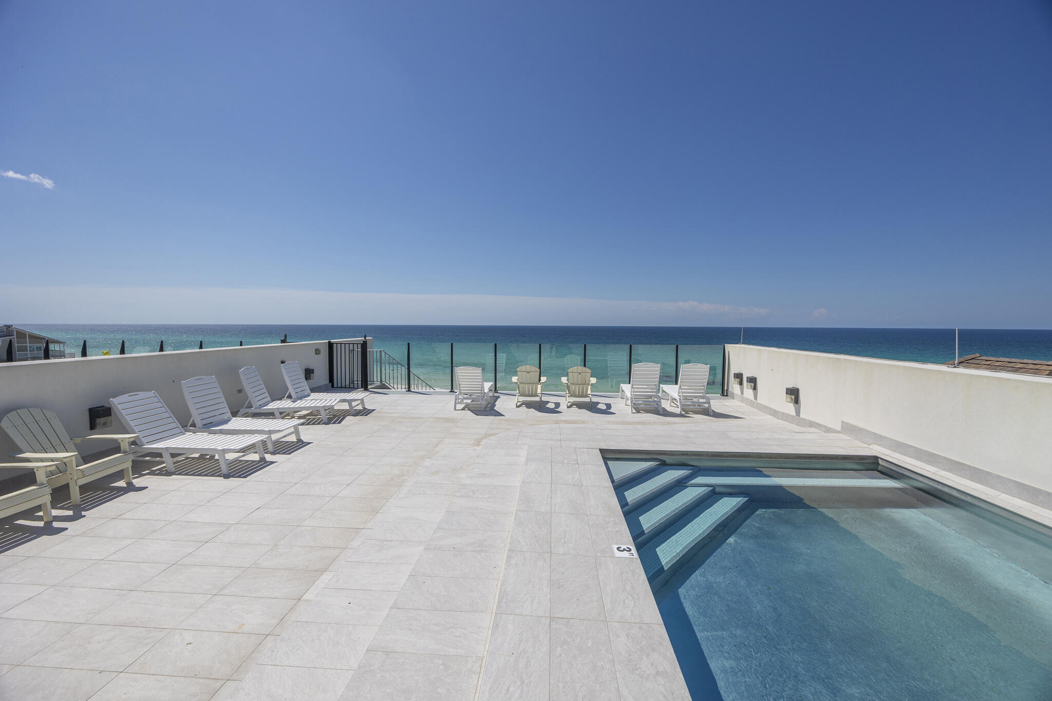 Perched along 109 feet of pristine Gulf frontage, this exceptional 4-bedroom, 4,272 sq ft coastal retreat offers a rare blend of space, privacy, and direct beach access via a shared dune walkover with Unit B, all set on nearly an acre of coveted shoreline. A rooftop pool & multiple Gulf-facing balconies provide a stunning backdrop of panoramic coastal views. Designed by Eric Craig of B. Design, the home reflects a sophisticated blend of architectural precision & coastal elegance. Interiors feature soaring 9-10ft ceilings, wood-look porcelain tile, spruce accents, custom mosaics, and curated designer lighting, creating a refined yet relaxed atmosphere throughout. Built with ICF construction & impact-rated glass, the residence prioritizes durability, efficiency, and comfort with multiple high-efficiency HVAC systems, integrated dehumidification, tankless gas water heating, and full smart-home capabilities. A crisp white exterior, paver drive, and spacious 3-car garage with additional parking enhance both form and function.

The first level is tailored for entertaining, featuring a spacious game room with wet bar and full bath, ideal for seamless transition from beach to home. A private elevator connects all four levels, each offering light-filled living spaces and Gulf-front vantage points. The rooftop terrace serves as a showpiece, complete with a stainless steel pool, expansive sun deck, and glass railings framing unobstructed views of the shoreline.

The main living level showcases an open-concept design where the kitchen, dining, and great room flow effortlessly together, all oriented toward the Gulf through expansive glass. Elevated details include a coffered ceiling, LED fireplace, and professionally curated interiors. The chef's kitchen is appointed with Sub-Zero refrigeration, a Wolf dual-fuel range with 8-burner gas cooktop, wine cooler, custom cabinetry, and striking backsplash.

Upstairs, two Gulf-front suites with private balcony access are complemented by a versatile living space with wet bar, offering both comfort and flexibility. The top level is dedicated to a luxurious primary suite with sweeping Gulf views, a spa-inspired bath, and generous walk-in closet, along with an additional Gulf-front guest suite and convenient pool bath.

Offered fully furnished and professionally designed, this turnkey property presents an outstanding opportunity as a primary residence, second home, or a high-performing investment. With proven rental success generating $229K in 2025, the property delivers both immediate income potential and long-term value. Smart-home integration allows for effortless remote management of climate, security, pool, and garage systems.

Tucked along a private, palm-lined street shared by only three other Gulf-front residences, Azzurro offers a rare balance of privacy and accessibility. Located in the heart of Seagrove Beach, it is just moments from the vibrant communities of Seaside, Alys Beach, and Rosemary Beach, as well as beloved local destinations including Old Florida Fish House, Buddy's Seafood Market, and Beachy Bean Coffee. Nearby coastal dune lakes, state parks, and scenic bike trails further enhance the lifestyle. Azzurro is a true Gulf-front retreat, where timeless design meets modern luxury in one of 30A's most sought-after settings.