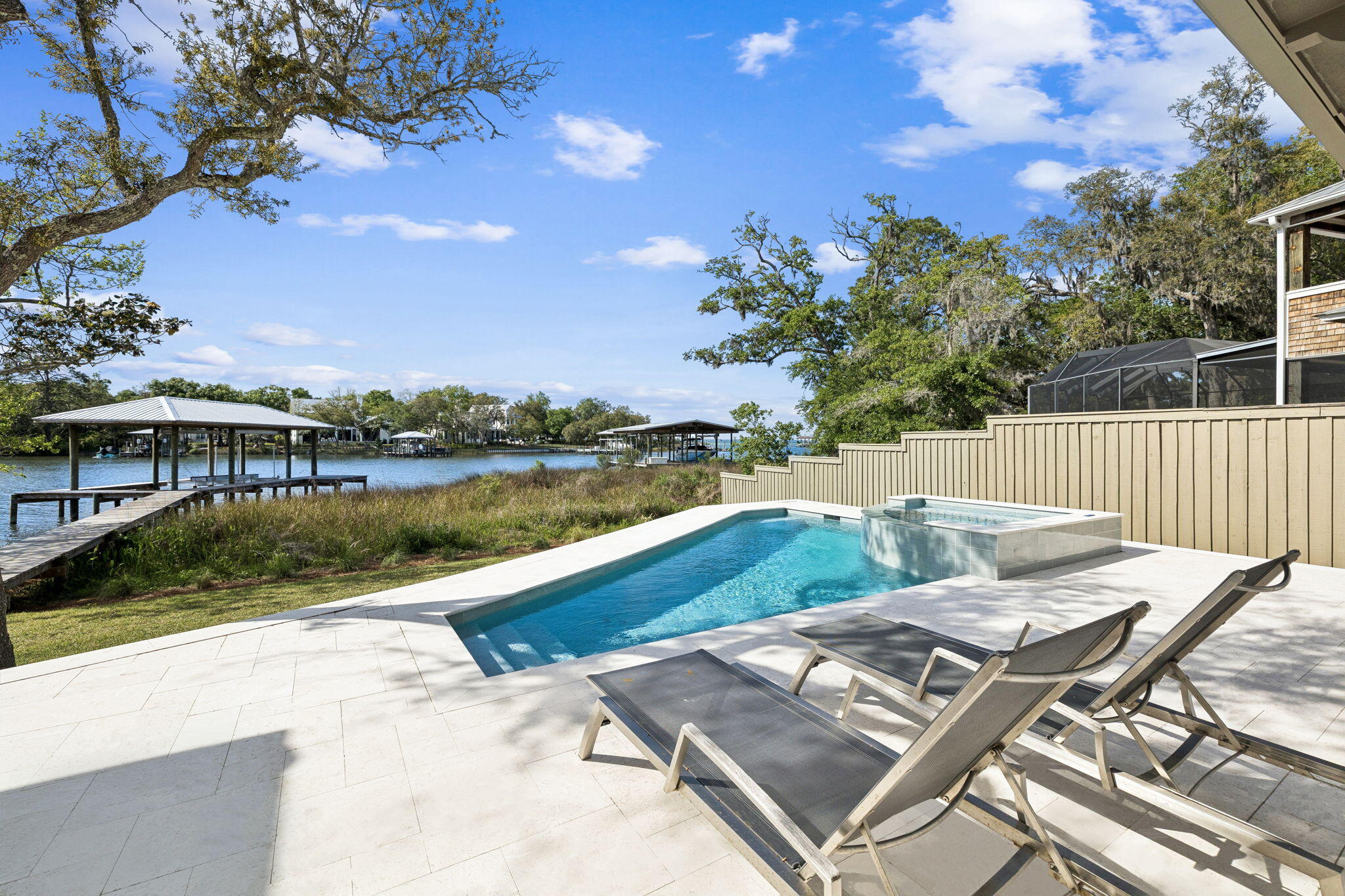 The waterfront home you have been waiting for. Tucked away on a private street under mature trees, this beautiful home offers a rare combination of privacy, deep-water boating access, and refined luxury living just minutes from the beach on 30A.


Completely renovated down to the concrete block and thoughtfully redesigned, the nearly 4,000-square-foot home offers the peace of mind and insurance advantages of nearly new construction. Timeless finishes include site-finished white oak hardwood floors, Bevolo lanterns, and a top-tier appliance package featuring dual 36-inch Sub-Zero columns, along with Wolf and Bosch appliances. A spacious butler's pantry and extensive custom cabinetry will delight both avid entertainers and serious home chefs.


Designed to capitlize on the stunning waterfront setting, the home captures beautiful bayou and bay views from the main living areas and the primary suite. The primary retreat, which occupies its own wing, features a step-free marble shower, cast-iron soaking tub, thoughtfully designed three-level closet system, private laundry, and a secure safe room.


Boating enthusiasts will appreciate the newly constructed covered dock with a 12,000-pound lift and access to some of the deepest protected waters in Santa Rosa Beach, accommodating larger vessels than many nearby waterfront properties, and a private slipway ramp makes launching paddleboards and kayaks effortless.


The home's western-facing orientation and folding glass wall create... seamless indoor-outdoor living, opening to an expansive pool deck where sunsets become a nightly ritual. The brand new pool and spa are just the icing on the cake.  Ideally located on the desirable west end of Santa Rosa Beach, you're less than 10 minutes from 30A's beaches, Grand Boulevard, Publix, and Butler Elementary School.