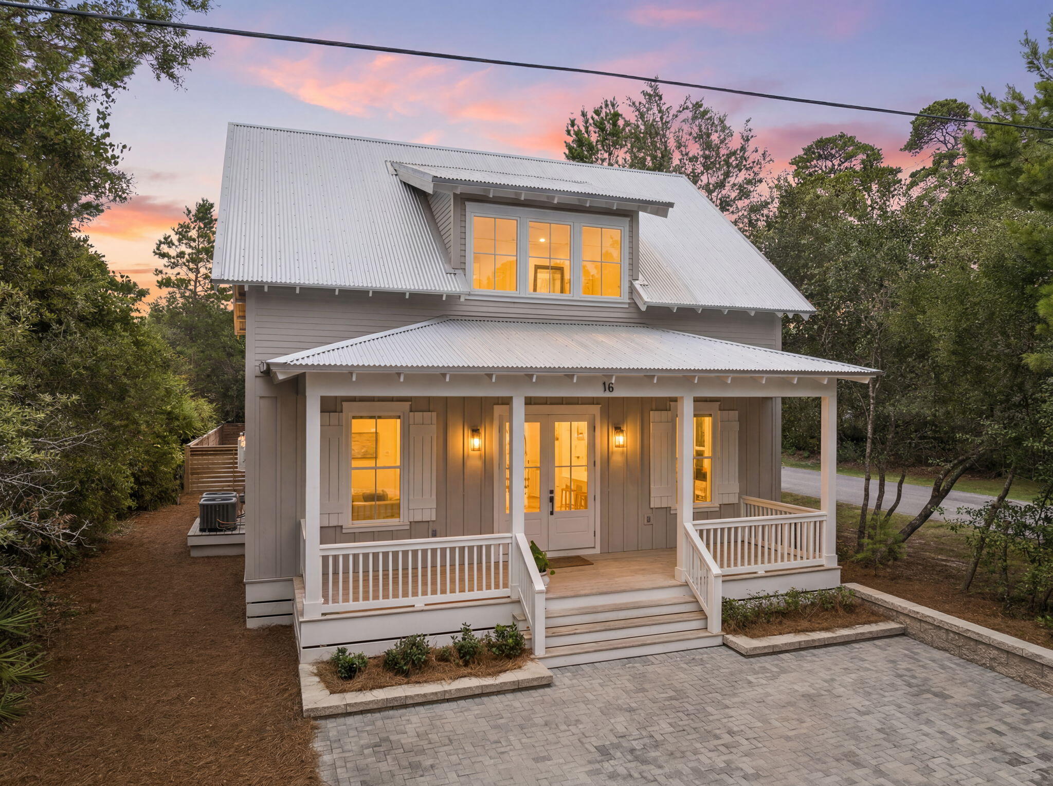 Tucked away on the quiet, tree-lined charm of Days Lane in the coveted Point Washington community, this exceptional Low Country Craftsman cottage offers a rare blend of timeless architecture, refined coastal design, and an unparalleled bayfront lifestyle. Just steps from Choctawhatchee Bay, residents enjoy access to a private neighborhood boat launch at the end of the street, making spontaneous days of boating, fishing, paddleboarding, and kayaking part of everyday life.

Positioned on a spacious corner homesite, the property is surrounded by mature landscaping and benefits from abundant natural light, generous outdoor space, and exceptional privacy. The beautifully designed backyard serves as an extension of the home, complete with a welcoming fire pit gathering area, creating the perfect setting for evenings with family and friends.

Inside, every detail has been thoughtfully curated with sophisticated coastal finishes, designer lighting, premium plumbing fixtures, and beautiful tile selections throughout. The open-concept main living area is both elegant and inviting, centered around a stunning chef's kitchen featuring an oversized island, custom cabinetry, and generous workspace for entertaining. A beautiful fireplace anchors the living room, while the adjacent dining room opens seamlessly to a spacious screened porch, blending indoor and outdoor living. The main-level primary suite offers a peaceful retreat with a spa-inspired bath and generous walk-in closet, while ample storage and a conveniently located powder bath complete the first floor.

Upstairs, three spacious guest suites each feature their own private en-suite bath, creating exceptional comfort and privacy for family and guests. A large laundry room and abundant additional storage complete the upper level.

Complementing the main residence is a detached two-car carriage house featuring its own kitchen, living area, and full bath--ideal for extended family, visiting guests, a private office, fitness studio, or additional entertaining space.

Beyond the property, Point Washington is celebrated for its authentic Old Florida character, quiet streets, and unmatched access to nature. Bordering the expansive Point Washington State Forest, residents enjoy miles of scenic trails perfect for hiking, trail running, cycling, and exploring, while the world-renowned beaches, restaurants, and shopping of 30A are just minutes away.

Offering an exceptional combination of craftsmanship, thoughtful design, outdoor living, and one of Santa Rosa Beach's most cherished bayfront neighborhoods, this is a home where luxury and lifestyle come together effortlessly.