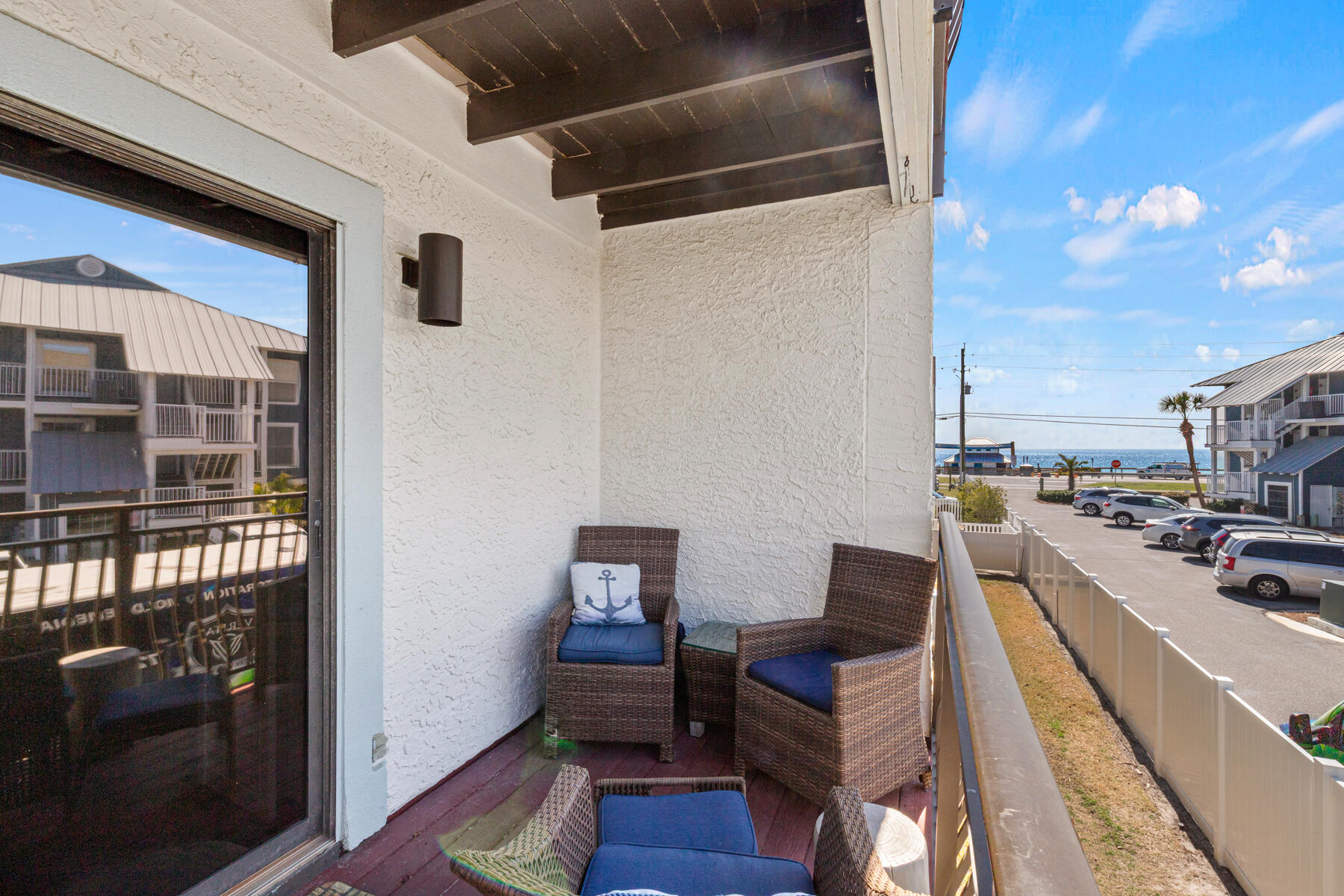 Beach life at an affordable price rings true with this townhome located across the street from the beach with GULF VIEWS! Covered parking for two vehicles and a small grassy area make this townhome a very unusual find! Conveying completely furnished this property features tile floors throughout, stainless steel appliances, beautiful tiled master shower, built in bunk beds, and much more! Not one but two balconies is where sunset dreams come true! Low HOA dues, only 10% down needed for financing, a beautiful setting and a community pool make for a prime opportunity! For those looking for an investment opportunity this property performs very well and has extensive bookings now through July! LOW HOA fees of only $1100 a quarter includes fiber internet, DirectTV, groundskeeping, roof and stucco maintenance.
