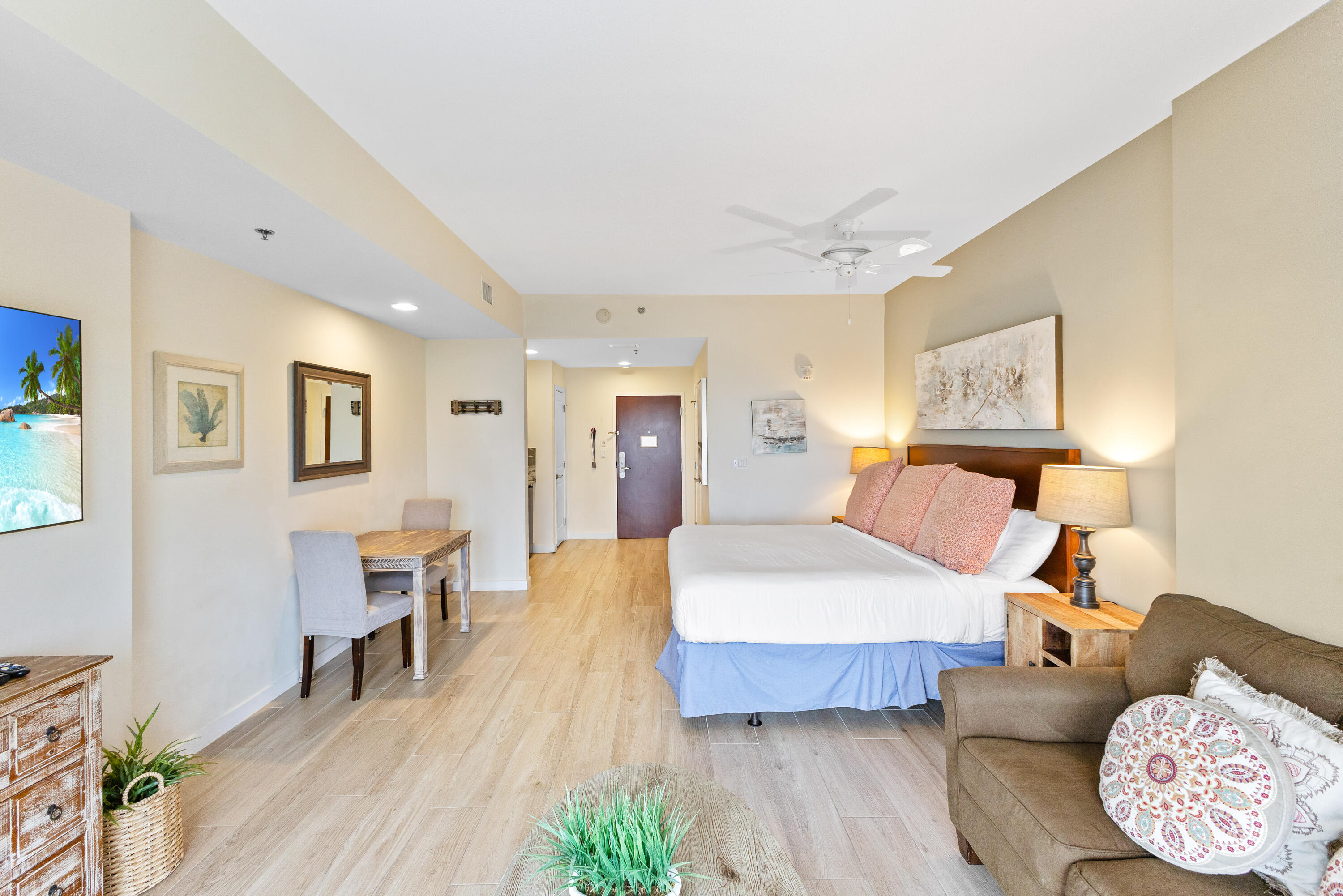 Located on the 11th floor of the sought-after Luau I building, this spacious 469 sq. ft. studio offers a serene beachside escape with a peek of the Gulf beyond. The elegant wood-look  ceramic flooring adds warmth and sophistication, creating a seamless, stylish ambiance throughout the space. Luau is a true resort oasis, boasting a heated lagoon-style pool with a tranquil waterfall, hot tub, grilling area, and a rooftop sundeck with breathtaking panoramic views stretching from the Gulf to the Bay. Stay active in the on-site fitness center or simply unwind and enjoy everything this coastal haven has to offer. Perfectly positioned on the beachside of Sandestin Golf and Beach Resort, Luau is just down from the sugar-white sand and  the Gulf, with easy access to all of Sandestin