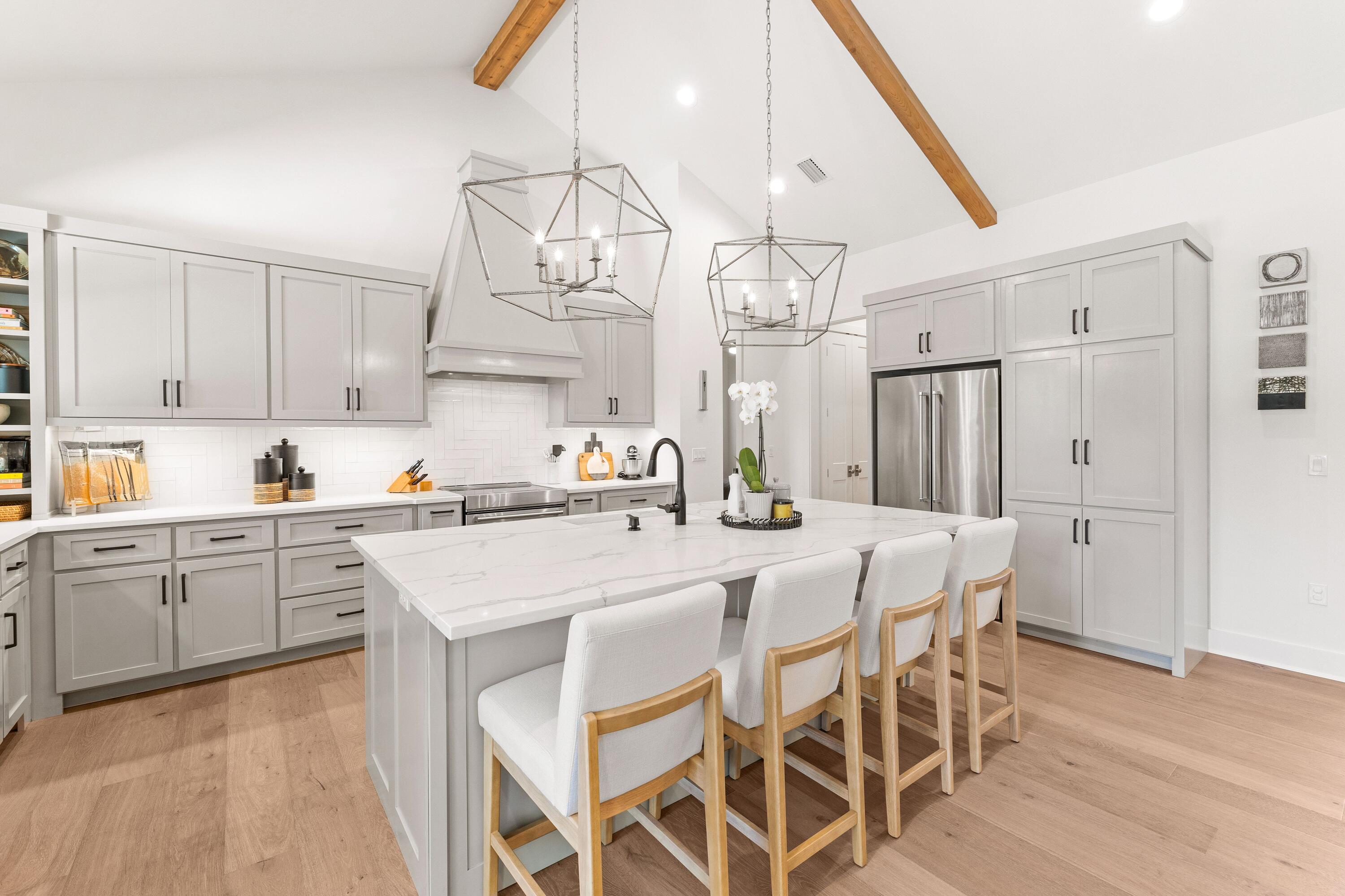 Introducing 51 Morning Sun Court, a beautifully crafted four-bedroom, three-bathroom home that perfectly blends luxury, comfort, and thoughtful design. Built in 2019, this custom single-level residence is located in the sought-after and rental-restricted Pelican Bay community--just minutes from Choctawhatchee Bay and a short drive to the stunning beaches of South Walton. Inside, an inviting open floor plan showcases 14-foot cathedral ceilings, a cast stone fireplace, and Pecky cypress accents that bring warmth and character throughout the foyer, kitchen, and dining areas. The gourmet kitchen features quartz countertops, a hooded induction range, KitchenAid appliances, and a spacious breakfast bar, creating the perfect setting for everyday living and entertaining. The primary suite offers a serene retreat with dual walk-in closets featuring built-ins and a spa-inspired bathroom complete with two vanities, a standalone soaking tub, and a walk-in tiled shower. Three additional guest bedrooms and two full bathrooms, all finished with quartz counters and ceramic tile, provide comfort and privacy for family and guests. A well-appointed laundry room, conveniently located off the garage, includes full countertops, a sink, and charming penny tile flooring. Outside, the fenced backyard offers generous space to create your own outdoor oasis, with room to add a private pool or patio area. Set on a meticulously maintained lot, this property is ideally positioned near top-rated schools, Grand Boulevard, and the Gulf of Mexico. Residents of Pelican Bay enjoy access to a bayfront park with a community dock, picnic area, and a pickleball and tennis court for the perfect balance of relaxation, recreation, and coastal living.