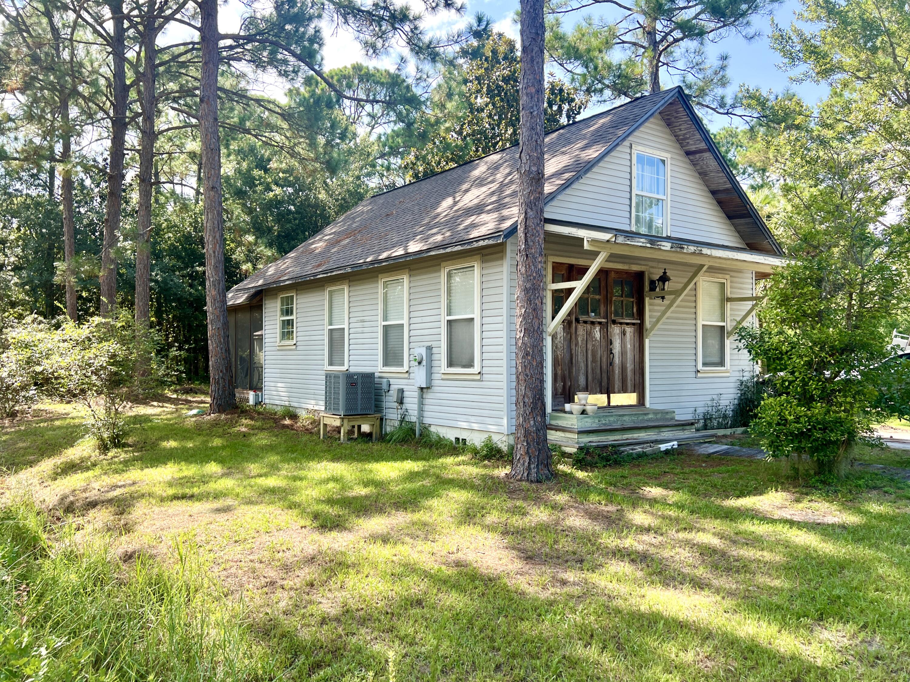 New roof installed May of 2023. New AC installed August of 2025. New flooring in Kitchen, Dining, Living Room, Bathroom, and a guest BR. Located in the heart of Santa Rosa Beach, this home offers an opportunity to own a versatile property just moments from the Cessna Landing public boat ramp on Hogtown Bayou. This prime location is perfect for boating enthusiasts, because of its quick and easy access to the water for fishing, kayaking, or sunset cruises on the Choctawhatchee Bay.  What sets this lot apart is its rear access, providing the perfect spot to park a boat, RV, or other recreational vehicles. Whether you're seeking full-time coastal living or a vacation retreat this property offers room to grow and flexibility to suit your lifestyle. The lot also has potential for a carriage house with income possibilities or to be used as a private space for family and friends. Enjoy quiet, local living just minutes from shopping, dining and the white sand beaches of 30A. This is your chance to embrace the laid-back Santa Rosa Beach lifestyle with boating and nature just steps from your front door.