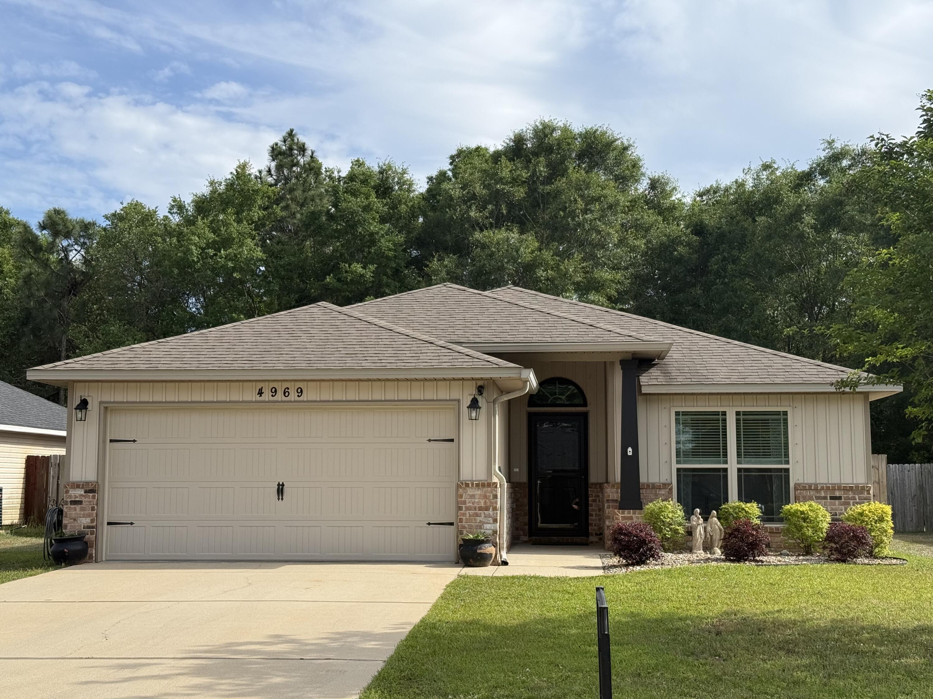 Welcome to this charming 3 bedroom, 2 bath home on an oversized lot in the Woodlands in Pace, FL This community features a neighborhood with playground, soccer field and walking trail. You'll love the open floor plan of this premium lot home boasting a living area, dining area and spacious kitchen with lots of cabinet space, granite countertops and pantry and laundry room. This home has LVP flooring with NEW carpet in the 3 large bedrooms. The primary suite, primary bath and HUGE closet are perfect! There is a covered back porch, extended wood deck and outdoor shower too! There is a large outdoor shed with power and the yard has plenty of room whatever your heart desires. Fully fenced backyard with a double gate make is easy to access the yard.