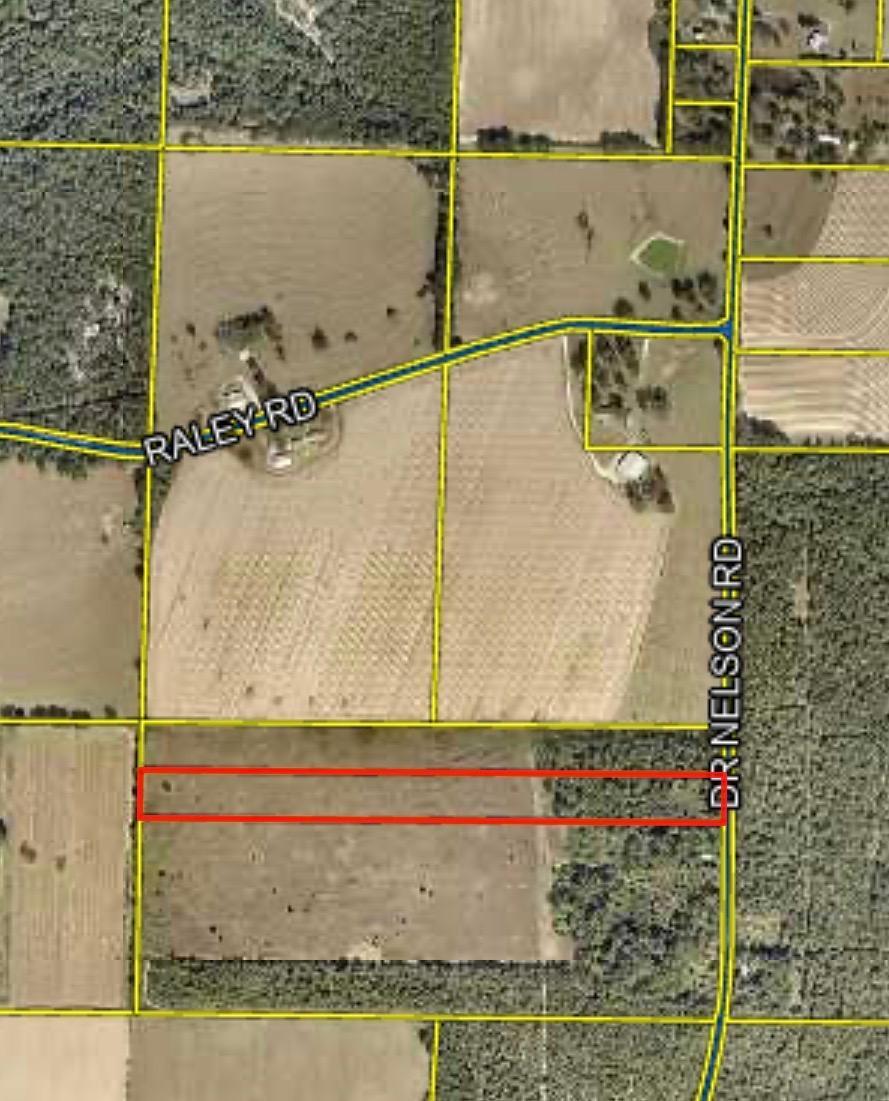 This beautiful +/- 13.33 acre property offers a level, wooded landscape with mature shade trees and pave road frontage.  The back half is partially cleared, providing a great balance of nature privacy and usable space.  Conveniently located close to town bordered by large adjoining parcels, it delivers both seclusion and accessibility.  This is the ideal setting for a homesite or retreat.