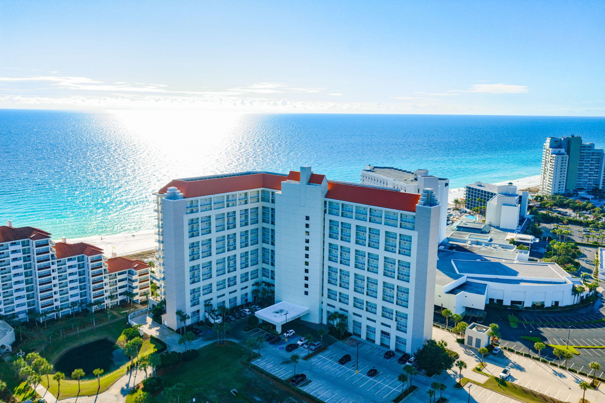 Penthouse luxury meets endless Gulf views in this rare, coveted corner unit at The Tides at Tops'l! Perched on the top floor, Unit 1401 boasts soaring 10-foot ceilings and an expansive wall of side windows in the living room that floods the space with natural light. Step out onto the massive wrap-around balcony to experience unparalleled, panoramic views of the coastline and emerald waters. The interior features significant upgrades throughout. The completely renovated kitchen showcases crisp white shaker-style cabinetry and striking Fantasy Brown countertops. The master retreat is a true sanctuary, offering a remodeled ensuite with a custom tiled walk-in shower, deep whirlpool tub, double vanity with shaker cabinets, and granite countertops. The guest bathroom is equally impressive, beautifully updated with custom tiled walk-in shower, a shaker-style vanity, and granite countertops. Located within the prestigious Tops'l Beach Resort, one of the area's most popular destinations, you will enjoy world-class amenities including pristine beach access, a state-of-the-art fitness club, championship tennis and pickleball courts, and multiple sparkling pools. Whether you are looking for a lucrative investment or a breathtaking coastal getaway, this penthouse delivers an unmatched luxury lifestyle. Schedule your showing today!