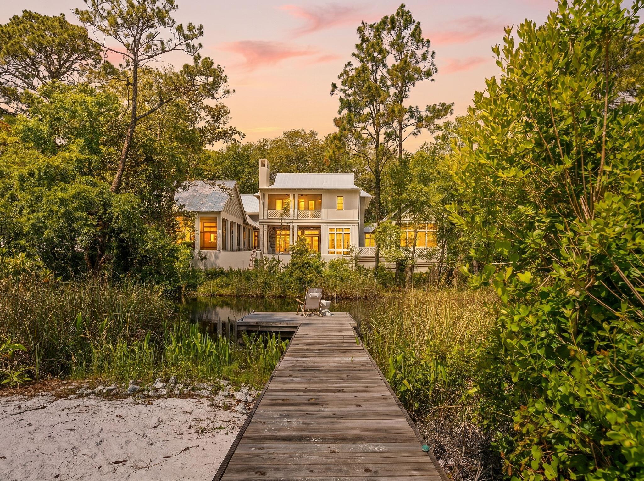 Tucked into the lush, canopied heart of Grayton Beach, this stunning 30A cottage offers a rare combination of dune lake frontage, beautifully curated interiors, and effortless coastal living. Set on over a fifth of an acre with 63 feet of lake frontage and a private boardwalk, 353 Wilderness Way is a true sanctuary.

Inside, vaulted ceilings with exposed wood beams soar above an open living space anchored by a dramatic floor-to-ceiling terrazzo fireplace with a live-edge mantel. French doors, a shell-and-crystal chandelier, and rich hardwood floors throughout complete the picture. The chef's kitchen impresses with white cabinetry, quartz countertops, a mosaic tile backsplash, gas range, and a large island. Three bedrooms offer peaceful retreats, and the thoughtfully finished bathrooms include a charming powder room with a teal vanity and antique gilt mirror. Multiple decks, a screened porch, and a spiral staircase connecting levels make outdoor living just as inviting as in -- with the dune lake steps away for kayaking, paddleboarding, or simply unwinding at the water's edge.

Steps from the beaches, dining, and boutiques that make Grayton Beach a perennial 30A favorite. Dune lake frontage like this is exceptionally rare - don't miss it.