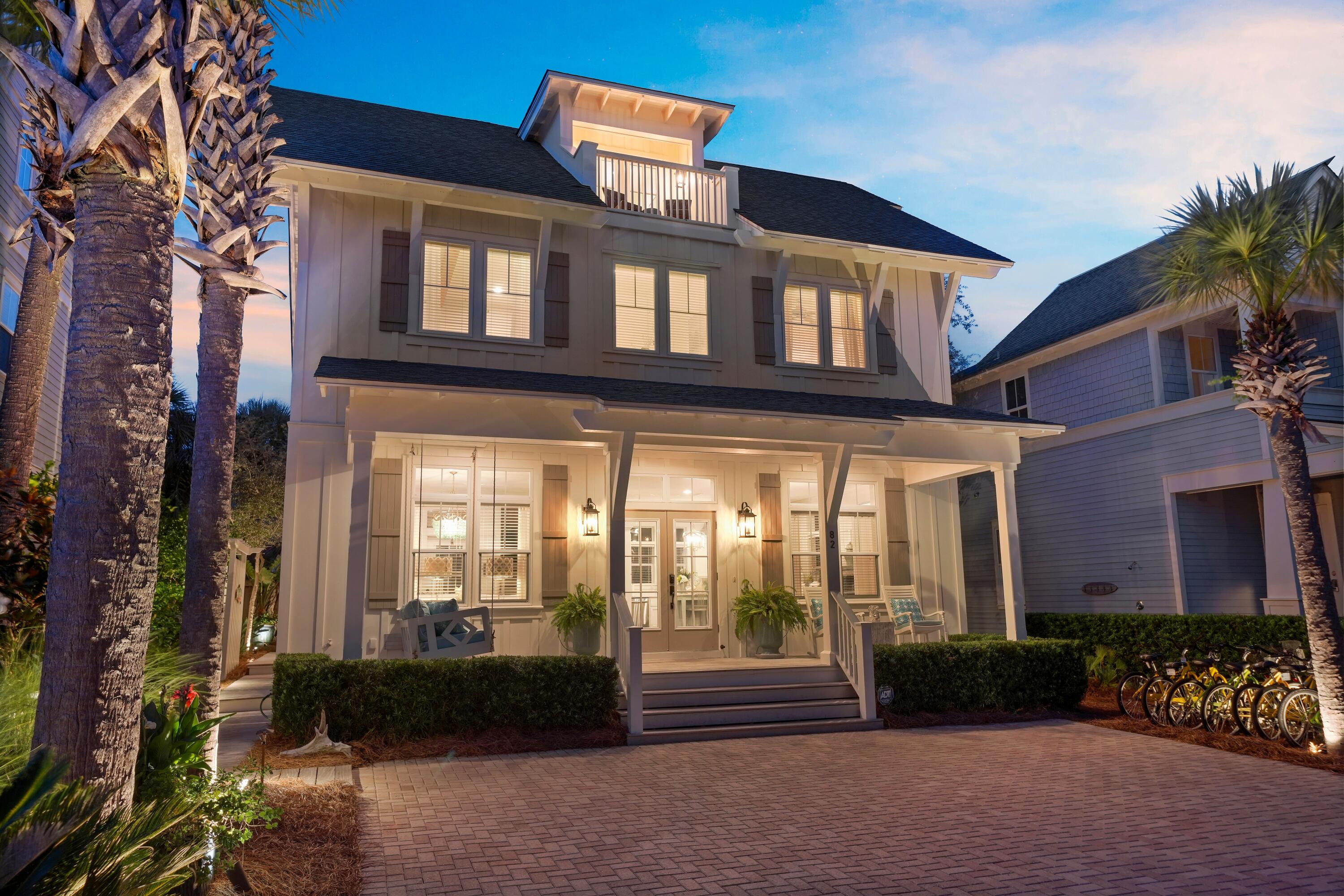 Ideally located in Seagrove Beach within the quiet, intimate setting of Magnolia Dune, 82 Sandalwood offers a rare balance of privacy and accessibility, just moments from the neighborhood pool and a short distance to the Gulf.
The home presents a strong architectural presence, with a deep front porch, expansive windows, and an inviting upper balcony. Outdoor living is well considered, featuring a spacious rear deck with pergola, gas grill connection, and enhanced privacy--recently improved for long-term durability .
Inside, the main level reflects a refined coastal aesthetic with hardwood flooring, ten-foot ceilings, and understated architectural detailing. The kitchen is both functional and elegant, finished with marble countertops, soft-close cabinetry, a pantry, and premium stainless appliances, including a Bosch five-burner gas range. The adjacent dining area accommodates larger gatherings with ease and is complemented by a serving bar with KitchenAid ice maker. A discreet powder room completes the level.
Upstairs, the primary suite is spacious and light-filled, with wood beam accents adding subtle character. The en-suite bath features marble surfaces, a walk-in closet, separate water closet, and a walk-in shower with classic tilework. Two additional guest bedrooms share a thoughtfully finished bath, while a dedicated laundry room with high-efficiency appliances and marble counters adds convenience.
The third level offers added versatility, enhanced by custom shiplap detailing along the stairwell. A den serves as a fourth sleeping area, complete with a king bed, sitting space, and access to a balcony with Gulf views. A fully renovated bath and adjoining bunk room with built-in queen-over-queen accommodations expand capacity while maintaining a cohesive design.
Extensive improvements--including updated HVAC systems, curated lighting, refreshed finishes, and professionally designed landscaping with integrated lighting--reflect consistent care and investment throughout.
The property has demonstrated consistent rental performance, underscoring its appeal as both a private retreat and investment opportunity.
Residents enjoy convenient access to the newly completed Seagrove Regional Beach Access, offering parking, restrooms, and ADA accessibility as well as the One Seagrove Neighborhood Beach Access, each approximately 350 yards from the home.