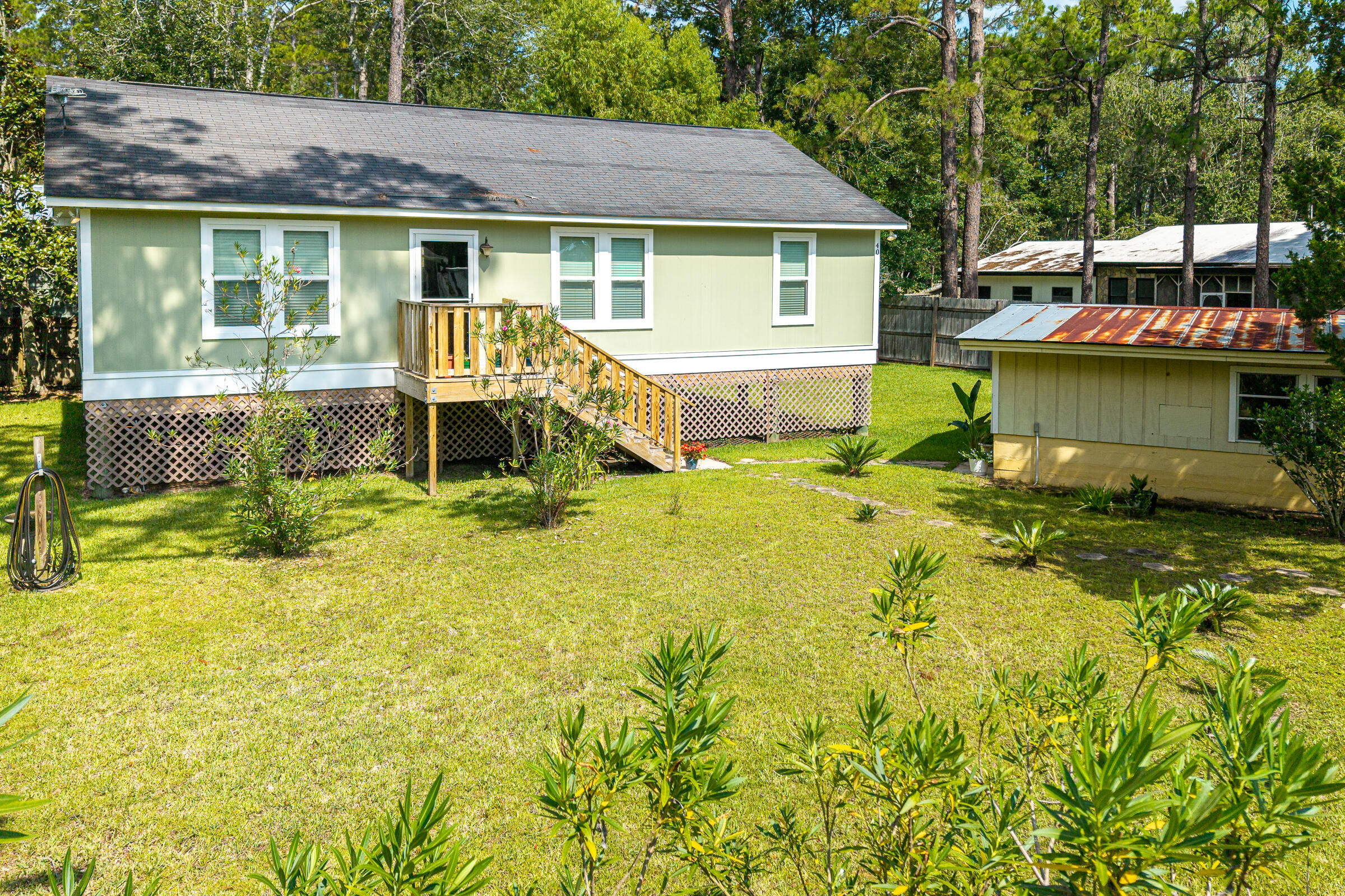 Charming 3-bedroom, 2-bath home, built in 2017, and perfectly situated on an oversized double lot in the heart of Santa Rosa Beach. Offering the ideal blend of coastal charm, functionality, and room to grow, this property is an outstanding opportunity for a primary residence, second home, or investment property.

Step inside to an inviting open-concept floor plan where the living, dining, and kitchen areas flow seamlessly together. Warm finishes, abundant natural light, and a relaxed coastal feel create a welcoming atmosphere that's perfect for everyday living or entertaining.

Outside, the possibilities are endless. The expansive double lot provides ample space to expand the home, guest house, or simply enjoy the privacy and extra outdoor living space. The property also features a detached garage, a separate workshop, and plenty of parking for your RV, boat, trailers, or other recreational toys.

Outdoor enthusiasts will appreciate the location, with Cessna Landing Public Boat Launch on Hogtown Bayou less than five minutes away, providing quick access to Choctawhatchee Bay for boating, fishing, and paddleboarding. Spend your afternoons on the sugar-white sands of Ed Walline Regional Beach Access, just 10 minutes away on scenic 30A.

Conveniently located just minutes from South Walton schools, Sacred Heart Hospital, shopping, dining, and local entertainment, this home offers easy access to everything Santa Rosa Beach has to offer!