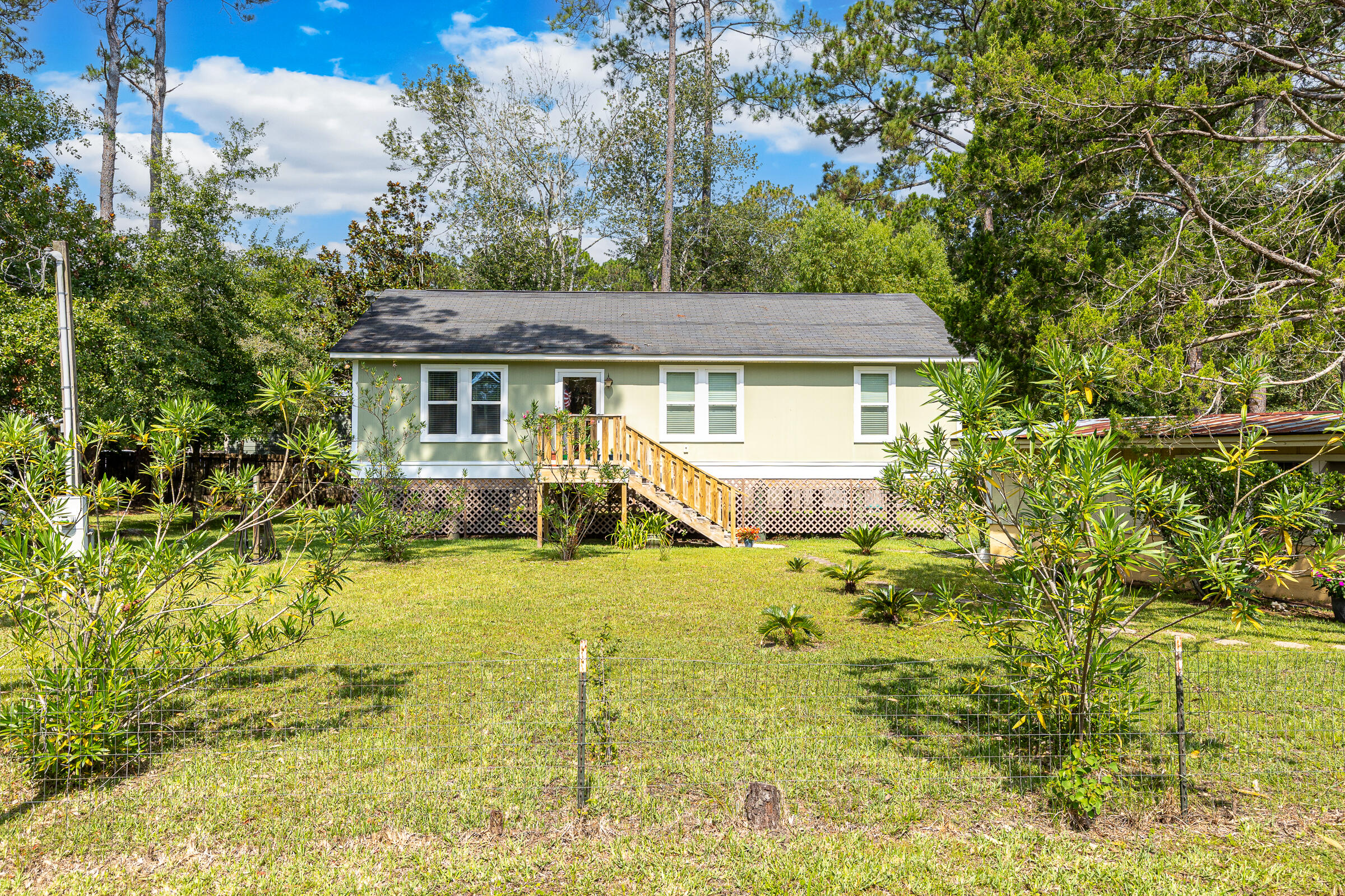 Charming 3-bedroom, 2-bath home, built in 2017, and perfectly situated on an oversized double lot in the heart of Santa Rosa Beach. Offering the ideal blend of coastal charm, functionality, and room to grow, this property is an outstanding opportunity for a primary residence, second home, or investment property.

Step inside to an inviting open-concept floor plan where the living, dining, and kitchen areas flow seamlessly together. Warm finishes, abundant natural light, and a relaxed coastal feel create a welcoming atmosphere that's perfect for everyday living or entertaining.

Outside, the possibilities are endless. The expansive double lot provides ample space to expand the home, add a pool, guest house, or simply enjoy the privacy and extra outdoor living space. The property also features a detached garage, a separate workshop, and plenty of parking for your RV, boat, trailers, or other recreational toys.

Outdoor enthusiasts will appreciate the location, with Cessna Landing Public Boat Launch on Hogtown Bayou less than five minutes away, providing quick access to Choctawhatchee Bay for boating, fishing, and paddleboarding. Spend your afternoons on the sugar-white sands of Ed Walline Regional Beach Access, just 10 minutes away on scenic 30A.

Conveniently located just minutes from South Walton schools, Sacred Heart Hospital, shopping, dining, and local entertainment, this home offers easy access to everything Santa Rosa Beach has to offer while maintaining a p