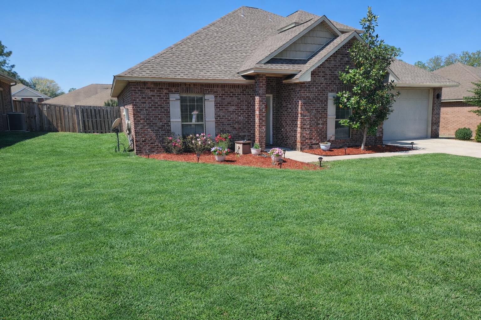 LOCATION, LOCATION, LOCATION!  Positioned south of I-10 in one of Crestview's most convenient and commuter-friendly areas, this large all-brick home offers exceptional access to the 7th Special Forces Group, Duke Field, Eglin AFB, Hurlburt Field, shopping, dining, and the white-sand beaches of the Emerald Coast. The interior features an open and functional floor plan with laminate wood flooring throughout the main living areas and neutral finishes. The spacious kitchen has granite countertops, stainless steel appliances, crown molding, a butcher-block island, and ample cabinetry, making it ideal for both everyday living and entertaining. The main-level primary suite offers a private retreat with a large walk-in closet, double vanity, garden tub, and a walk-in granite shower. Secondary bedrooms are generously sized and provide flexibility for family, guests, or home office use. Upstairs, a large bonus living area with its own full bath adds exceptional versatility and can easily serve as a media room, guest suite, playroom, or additional living quarters. Outdoor enjoyment is enhanced by a privacy-fenced backyard and patio area, perfect for relaxing or hosting gatherings. Major system updates provide added peace of mind, including a newer roof installed in March 2022, a new HVAC system in April 2025, and a new water heater installed in January 2026. This well-located and move-in-ready home offers space, functionality, and convenience in one of Crestview's most established communities.