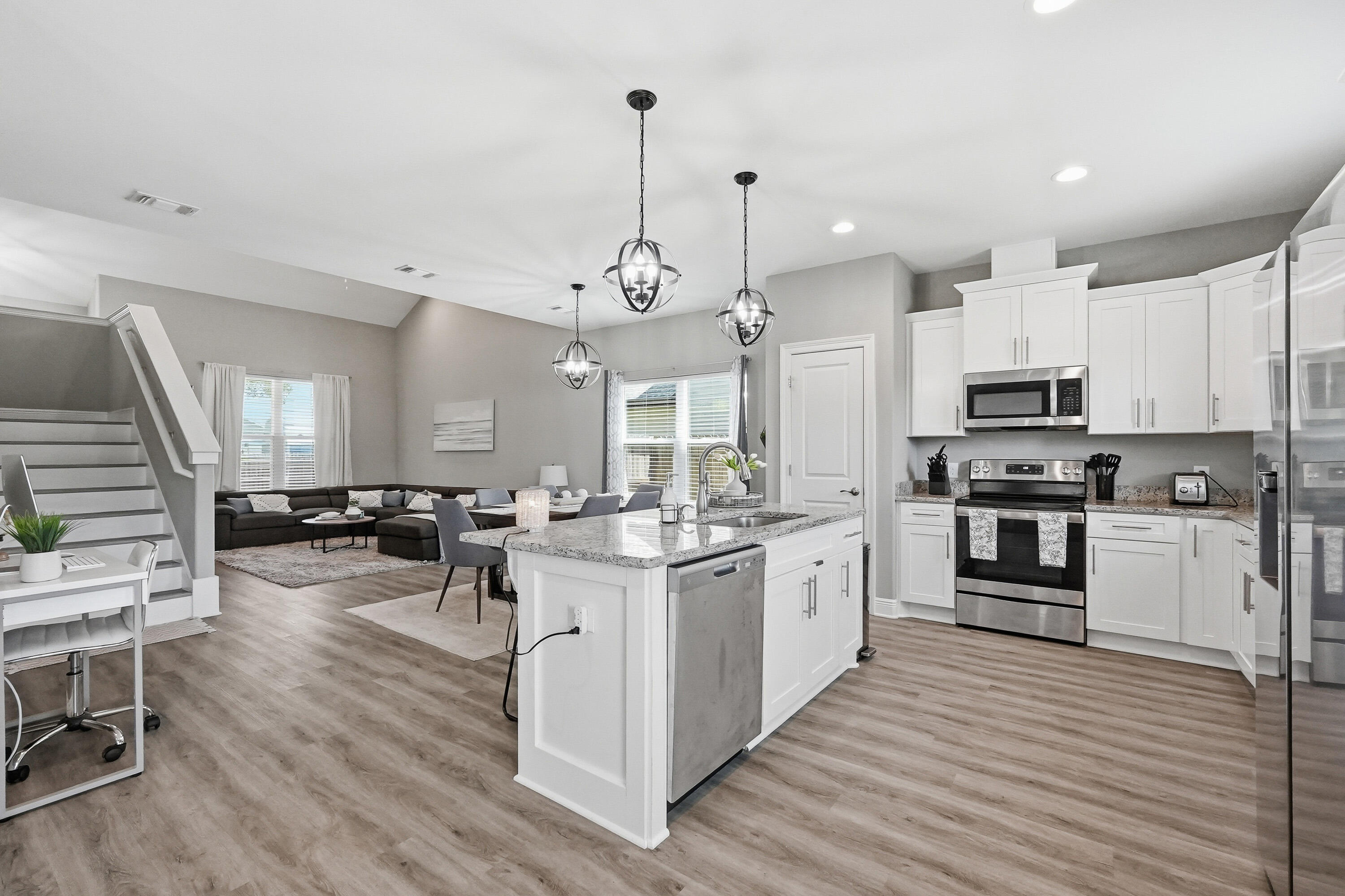 Welcome to 2331 Hadleigh Hills Court a move in ready 2022 Robbins Builders home offering modern finishes, functional living spaces, and easy access to Navarre Beach, Hurlburt Field, shopping, dining, parks, and Highway 98.
Inside, the open-concept layout creates a natural flow between the kitchen and two spacious living areas, making the home feel both comfortable and connected. Large windows bring in abundant natural light, giving the main living spaces a bright and welcoming atmosphere. The kitchen serves as the heart of the home and features white shaker cabinetry with crown molding, granite countertops, stainless steel appliances, an undermount sink, and a large center island with bar seating and additional prep space. Luxury vinyl plank flooring runs throughout the home, offering durability, easy maintenance, and a clean modern look.
The primary suite provides a relaxing retreat with dual granite vanities, undermount sinks, and an oversized tiled walk-in shower. Three additional bedrooms offer flexibility for guests, a home office, hobbies, or additional living space. The covered back patio overlooks a privacy-fenced backyard with a peaceful setting and no direct rear neighbors. Additional features include an EV charger in the garage, built-in hurricane shutter system with custom fabric shields, and a hot tub that conveys with the property.
Designed with both comfort and functionality in mind, this home offers a modern layout, thoughtful upgrades, and a peaceful setting all within minutes of the Emerald Coast lifestyle buyers love.