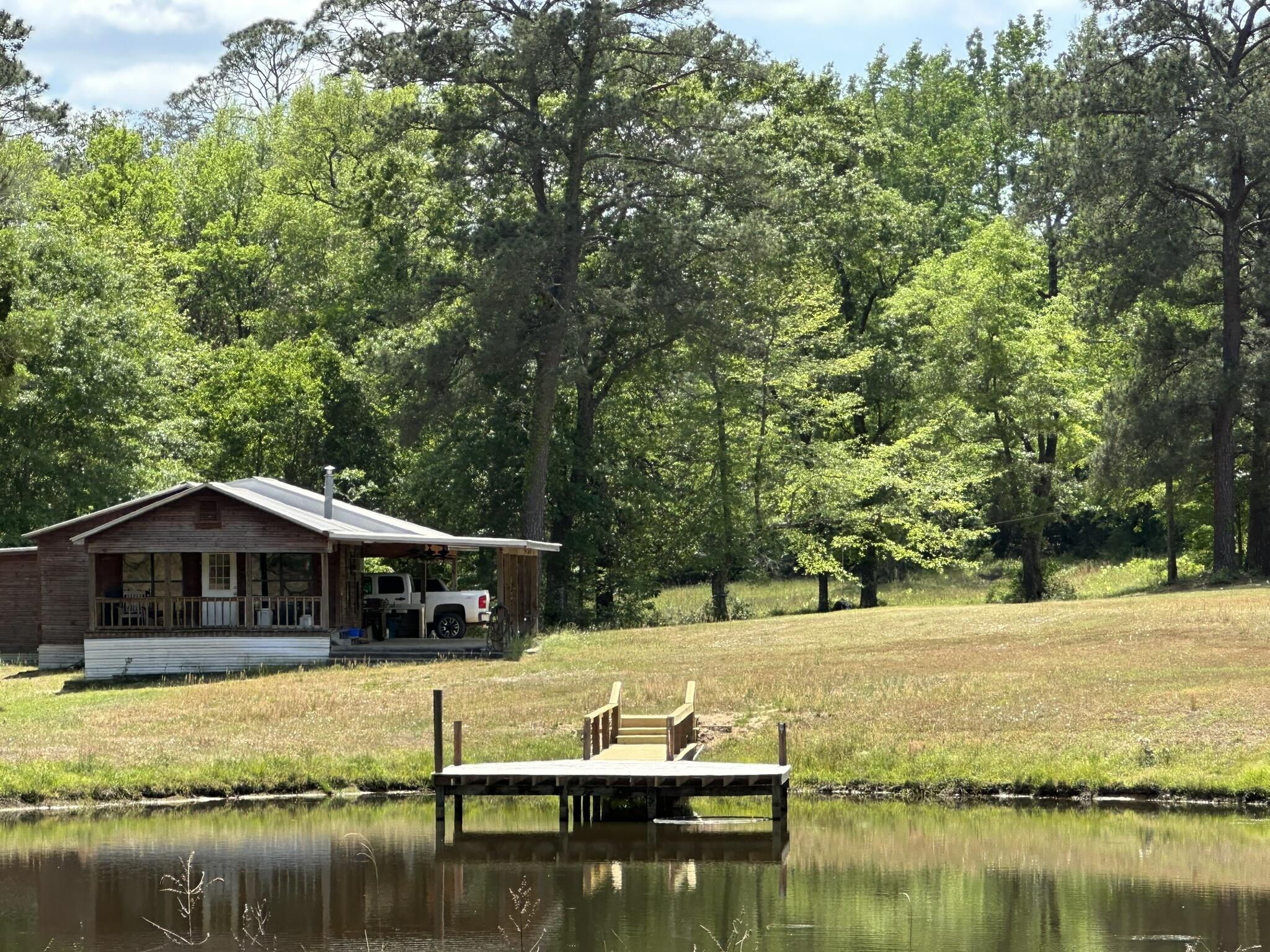 143.09+/- acres spanning Florida and Alabama with a rare multi-parcel setup offering a blend of recreational land, wooded acreage, open space, and functional improvements. The offering includes two parcels totaling approximately 85 acres in Laurel Hill, Florida, along with an additional parcel in Florala, Alabama, featuring a cabin, outdoor fish/game cleaning station, and multiple storage areas.
Whether used for hunting, outdoor recreation, agricultural pursuits, weekend escapes, or future plans, this property offers ample space to spread out and enjoy the land. The cabin provides a central gathering point after long days outdoors, while the acreage offers a variety of terrain and use potential across both states.